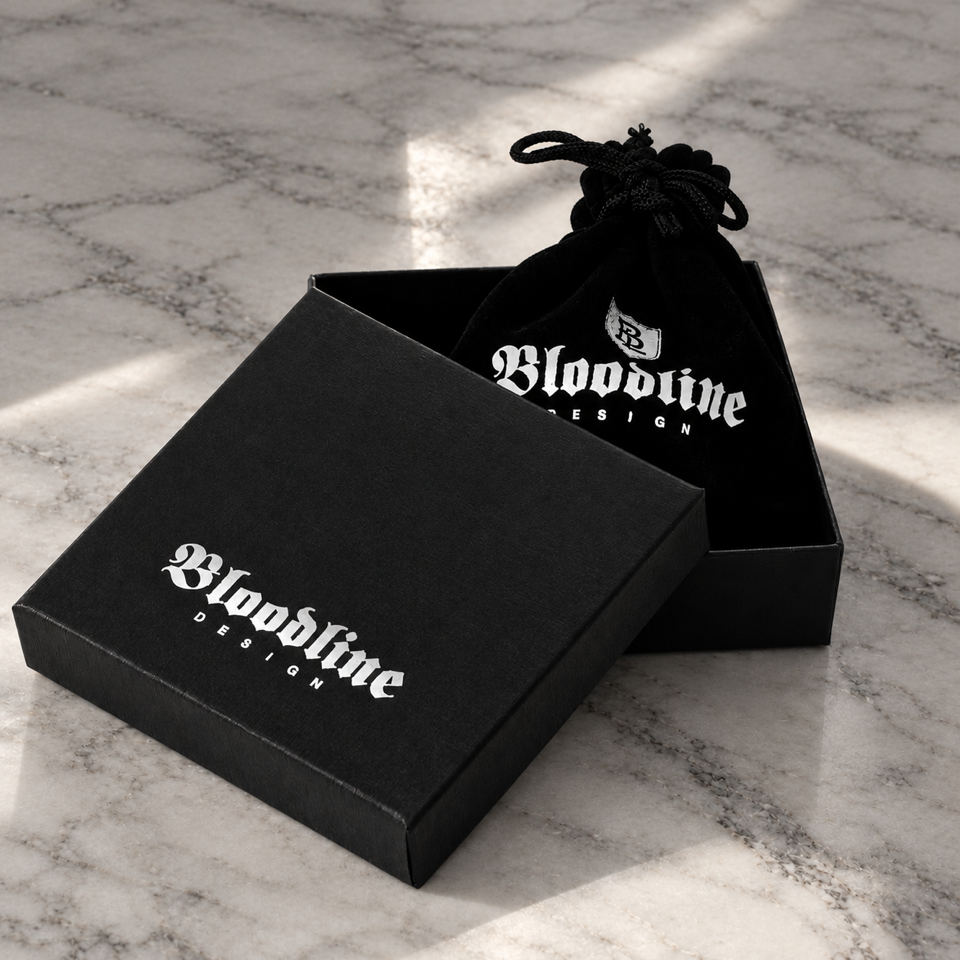 Black Bloodline Design jewelry box and branded drawstring pouch on a marble surface.