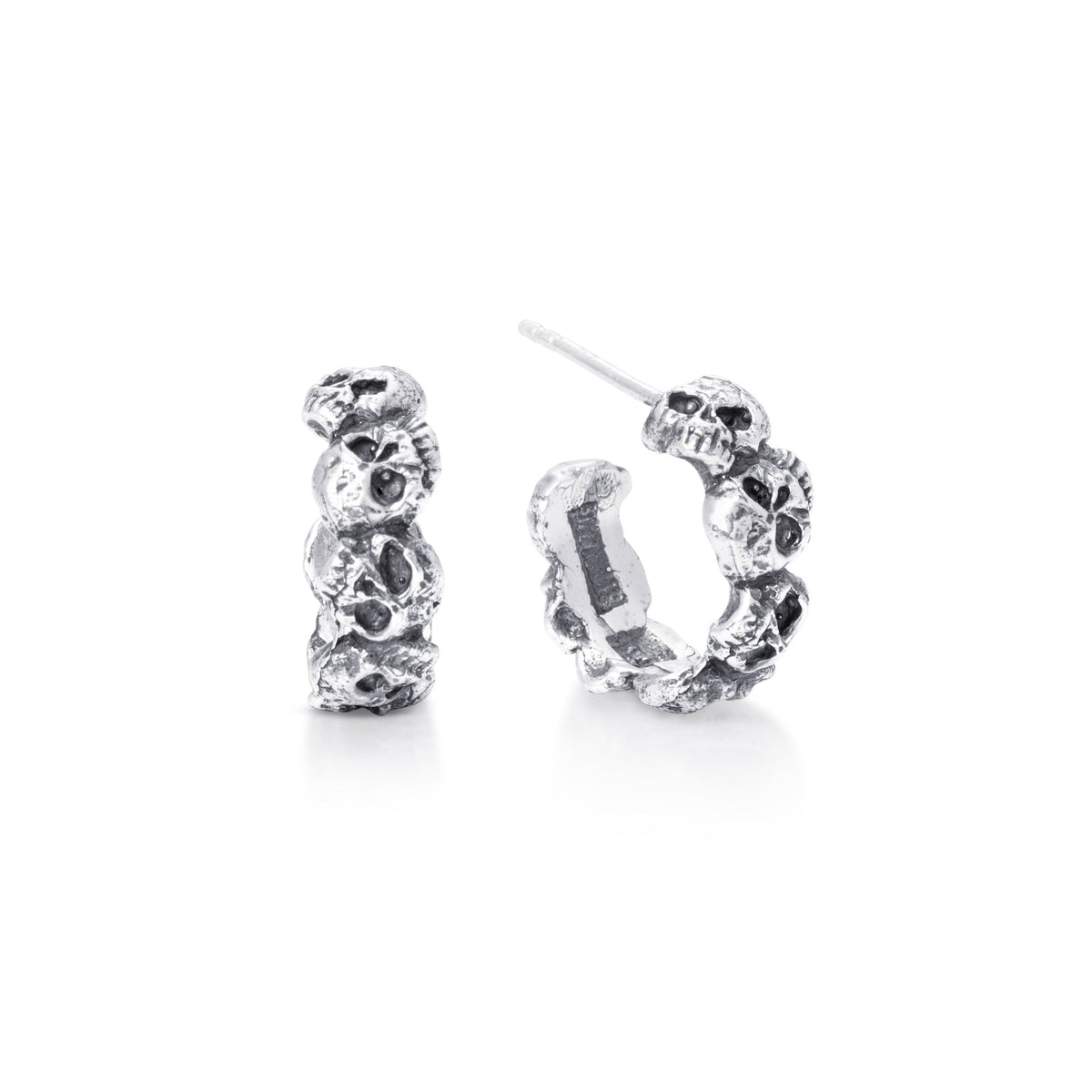 A pair of sterling silver hoop earrings with a skull design, post backings, and a silver wire hook.
