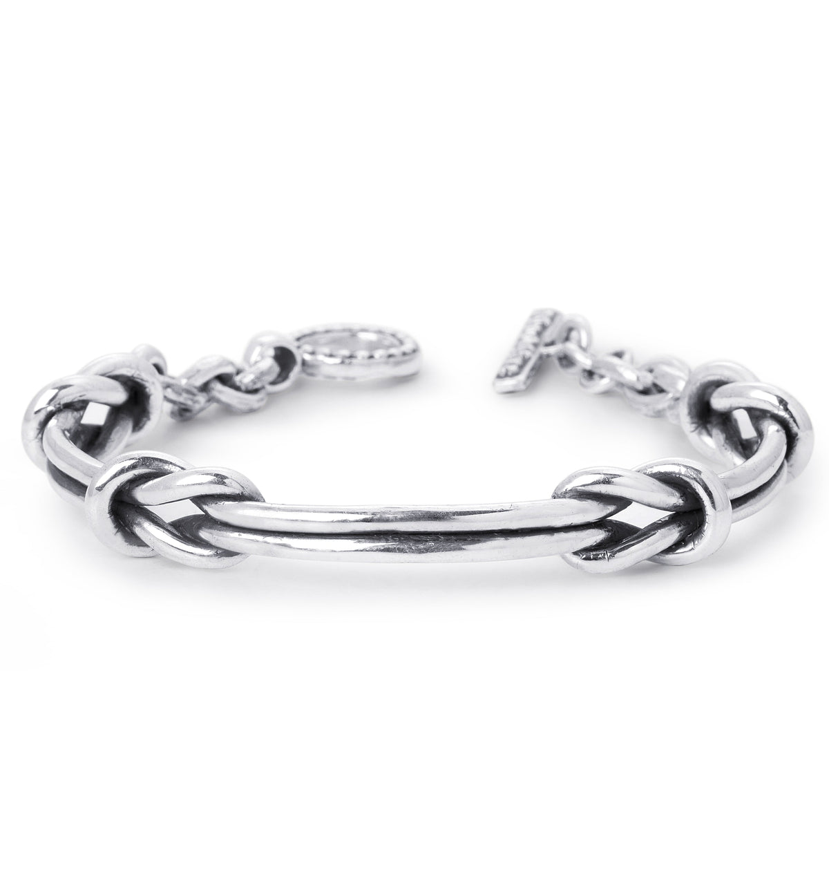 a sterling silver cuff bracelet with two nautical knots on a white background