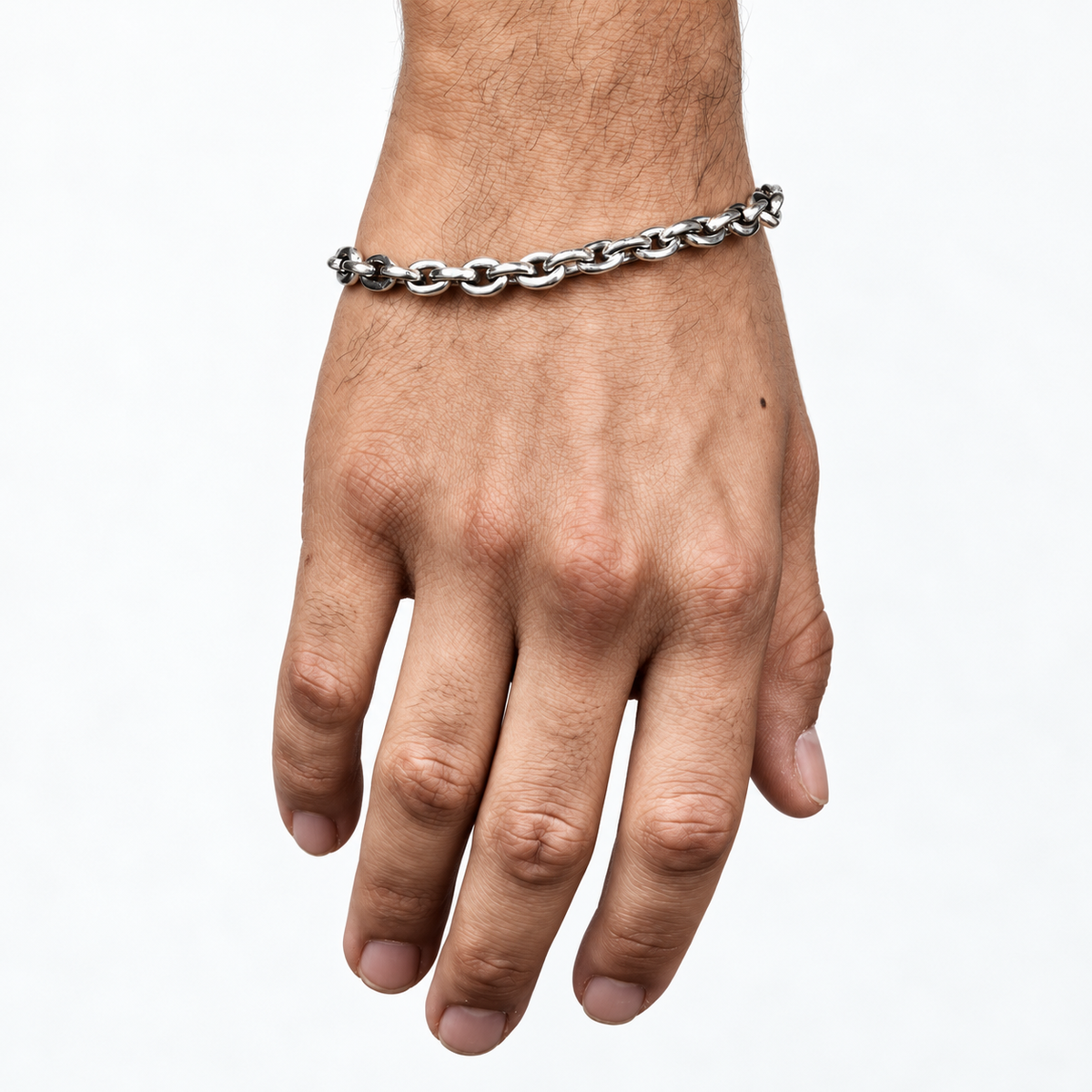 mens sterling silver chiseled bracelet on a male wrist on a white background.