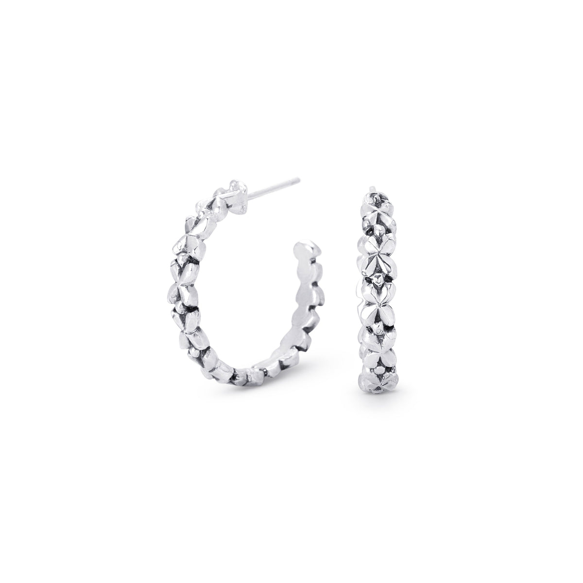 A pair of silver hoop earrings with a textured, floral design, shown on a plain white background.