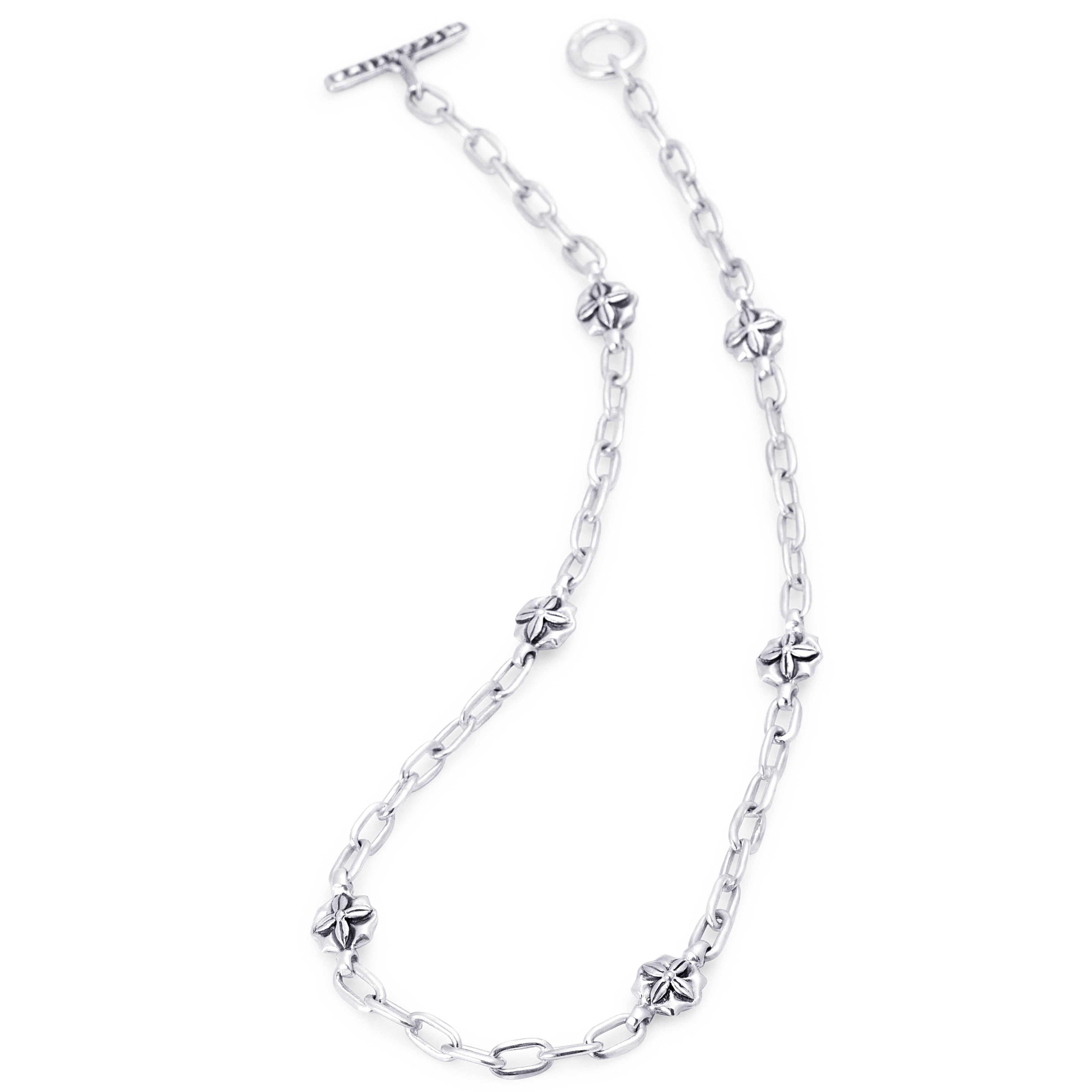 A silver chain bracelet featuring small clover-shaped links and a T-bar clasp, shown on a plain white background.