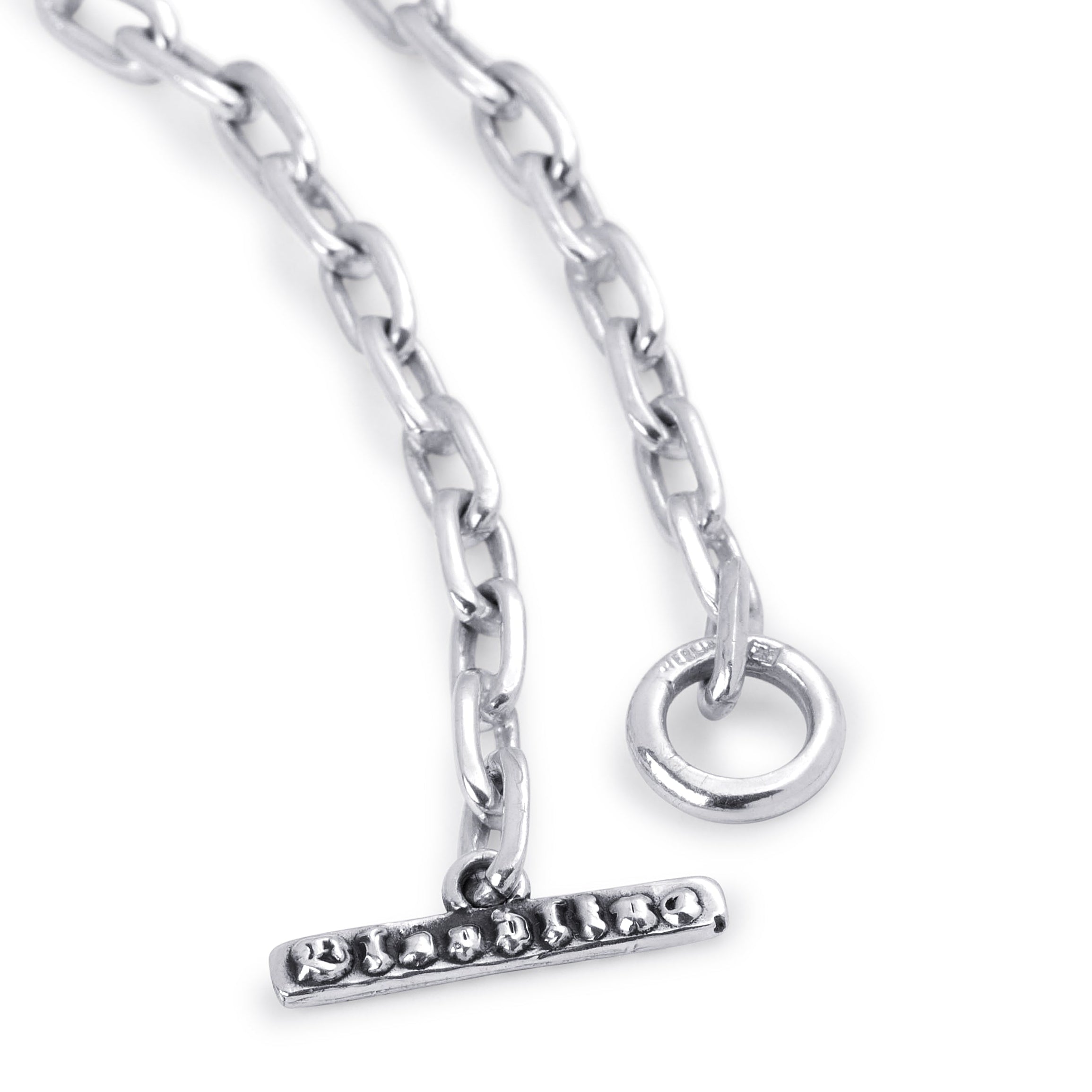 A close-up of a silver-toned chain necklace with a bar clasp adorned with small clear stones and a circular ring connector, shown on a plain white background.