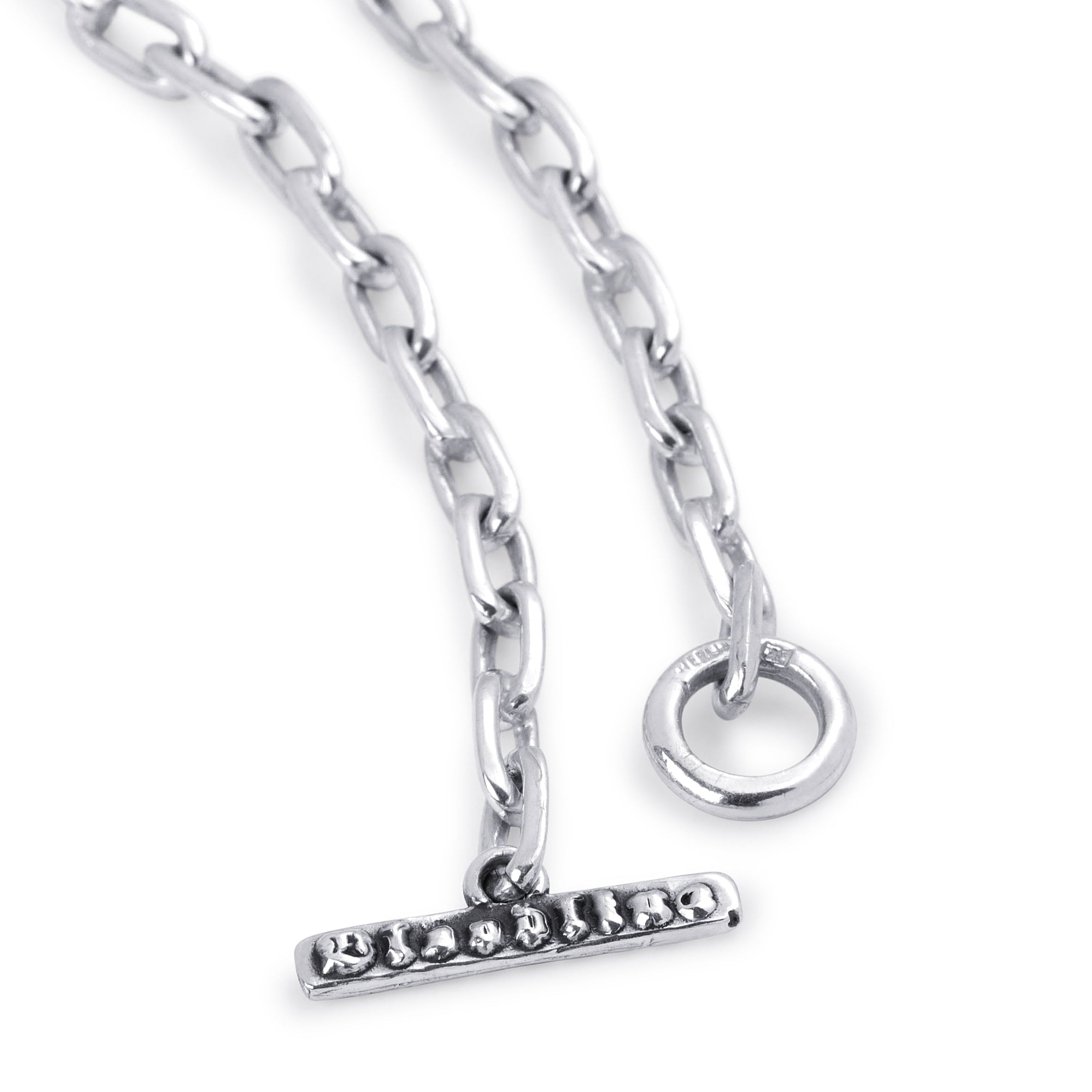 A close-up of a silver-toned chain necklace with a bar clasp adorned with small clear stones and a circular ring connector, shown on a plain white background.