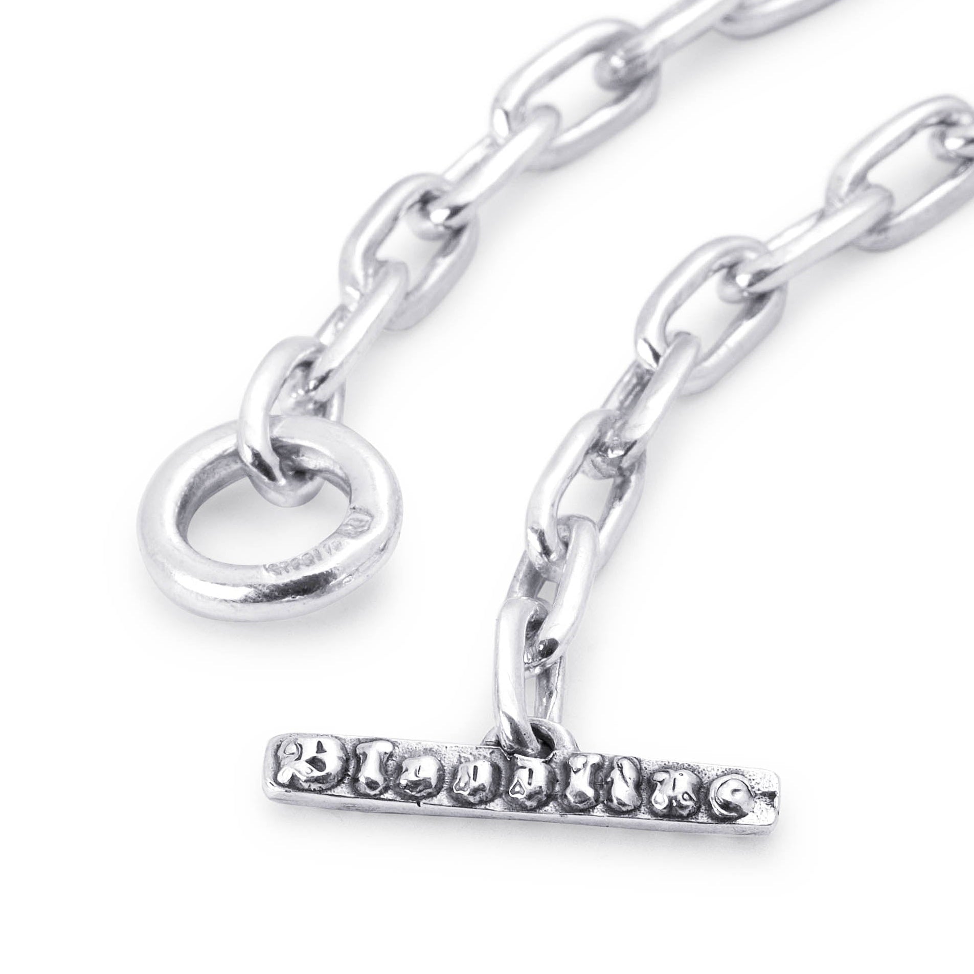 Close-up of the London Link bracelet’s sterling silver toggle clasp with raised Bloodline lettering.