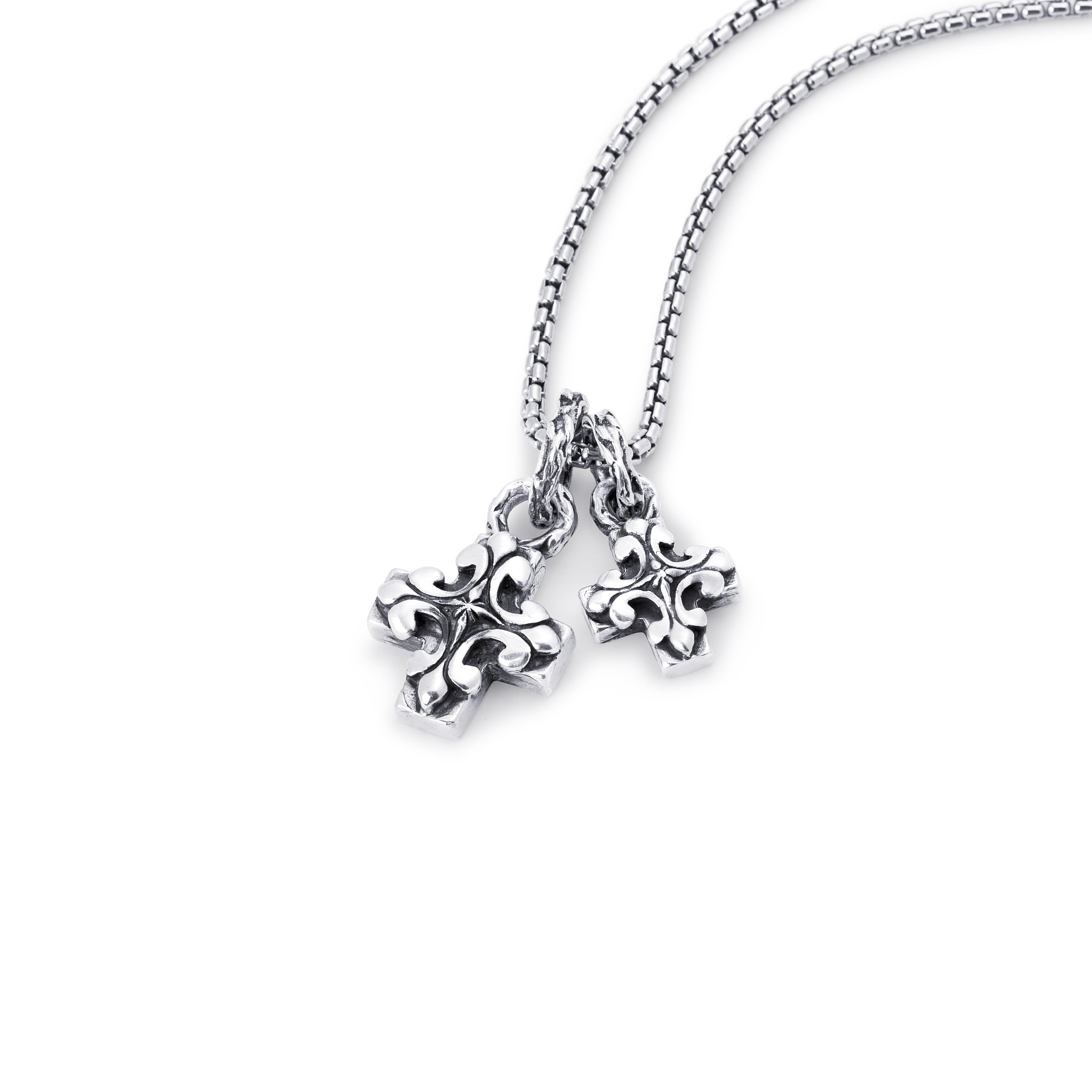 A sterling silver chain necklace with two dangling ornate fleur-de-lis style charms, shown on a plain white background.