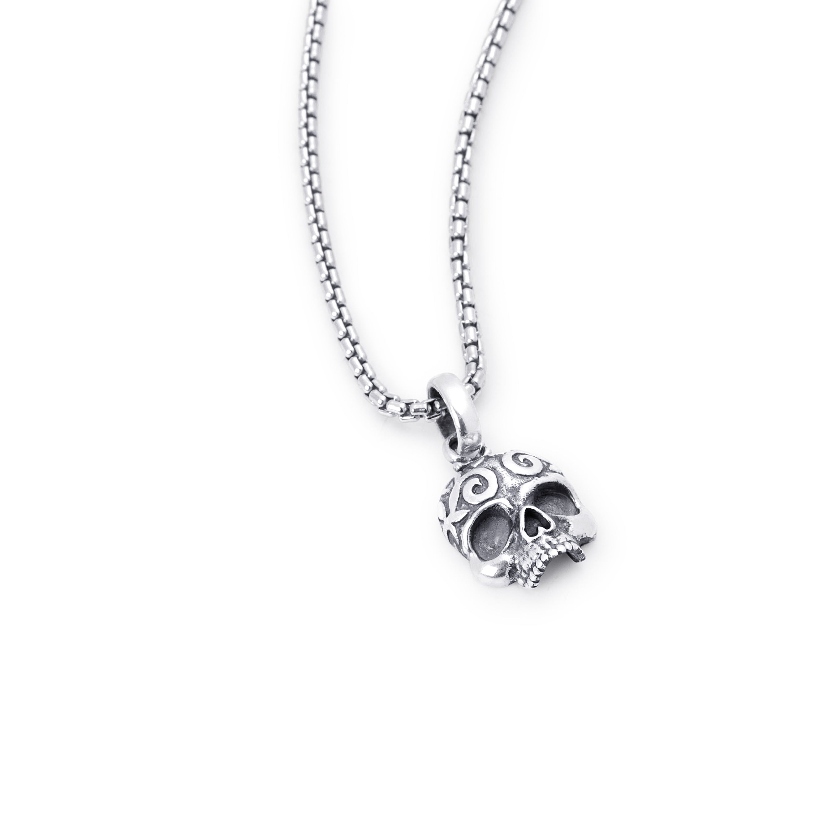 A sterling silver skull pendant necklace with a detailed filigree design, hanging from a matching box chain against a plain white background.