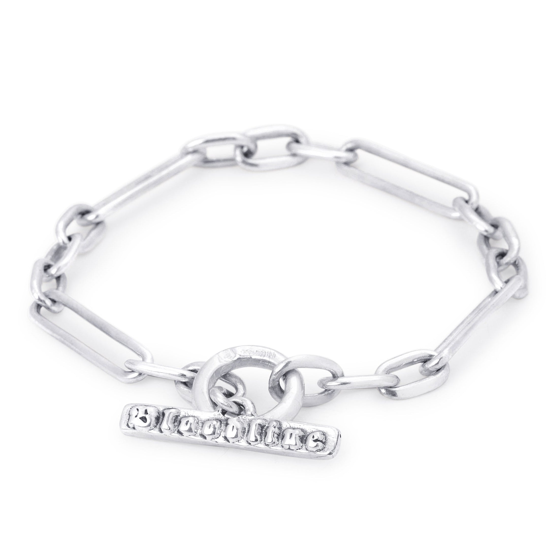 A silver paperclip trombone chain bracelet with a toggle clasp featuring, shown on a plain white background.