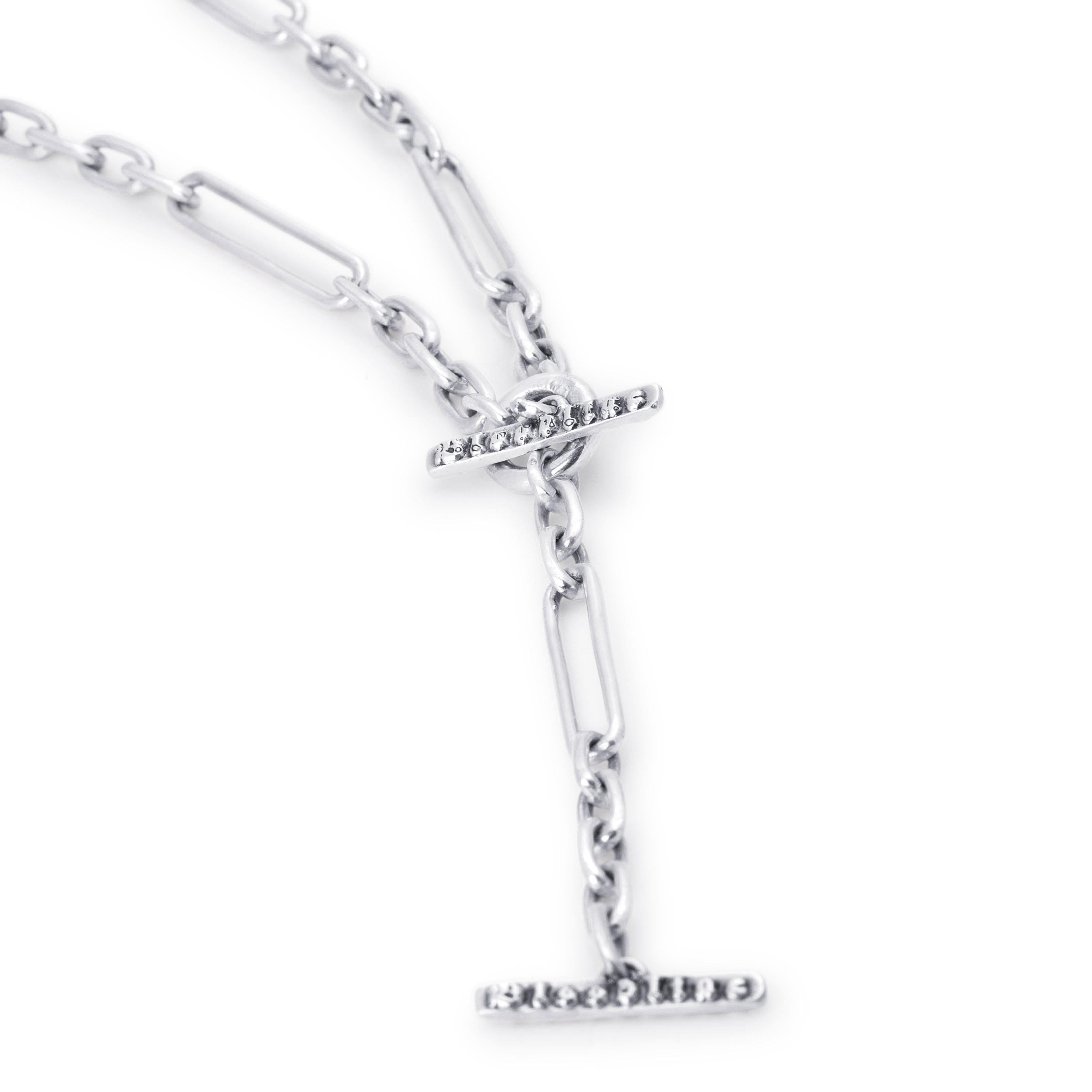 A silver paperclip chain necklace with a T-bar clasp adorned with small clear stones, shown on a plain white background.