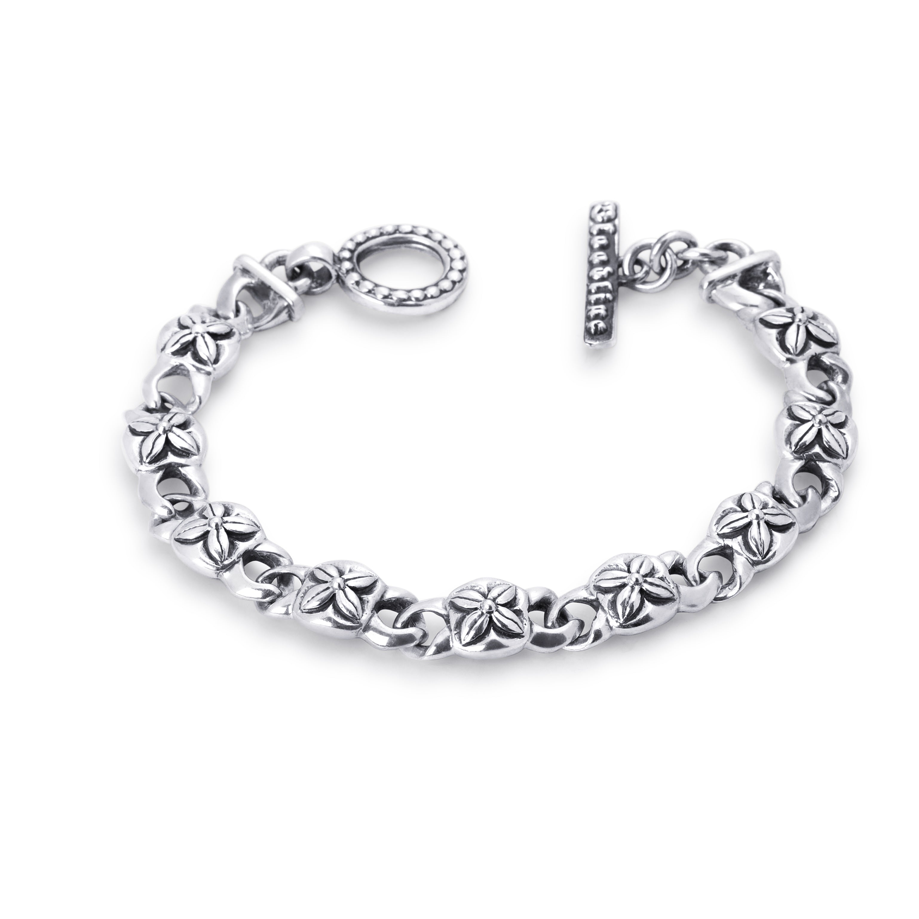 A sterling silver chain bracelet with textured, flower-like links and a toggle clasp, displayed on a clean white background.