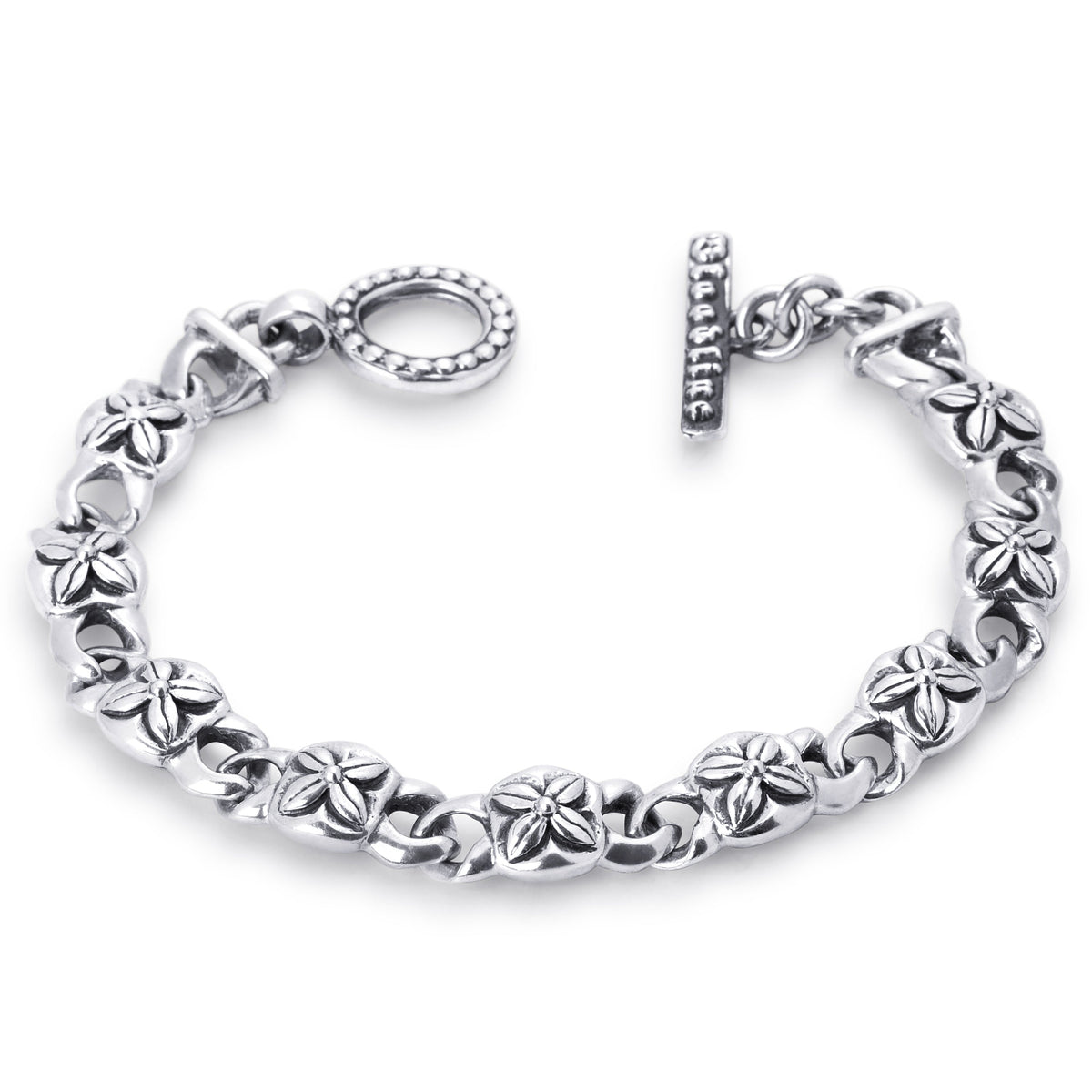 A sterling silver chain bracelet with textured, flower-like links and a toggle clasp, displayed on a clean white background.