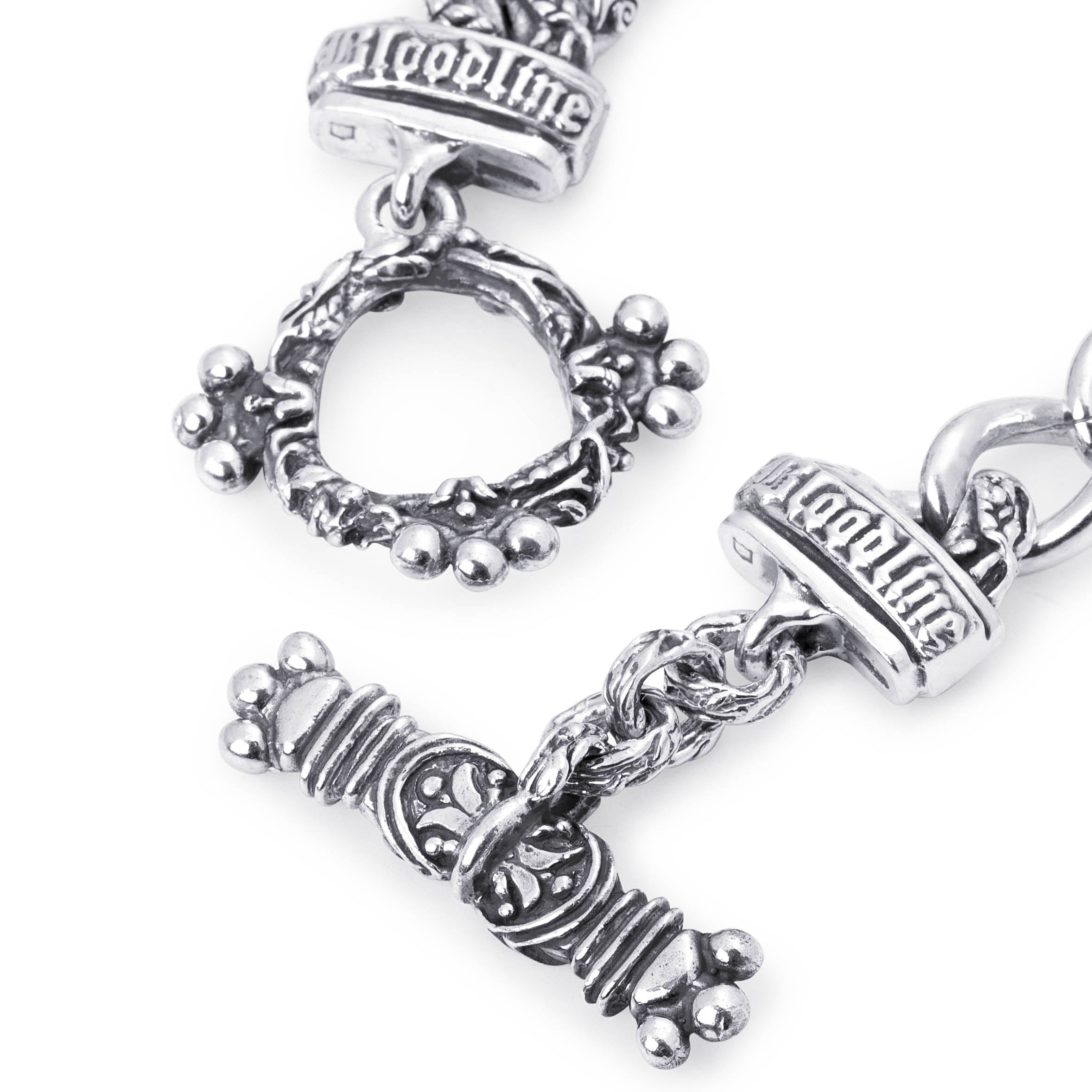 Close-up of the Half and Half bracelet’s ornate silver toggle bar and sculpted clasp ring with raised Bloodline lettering.