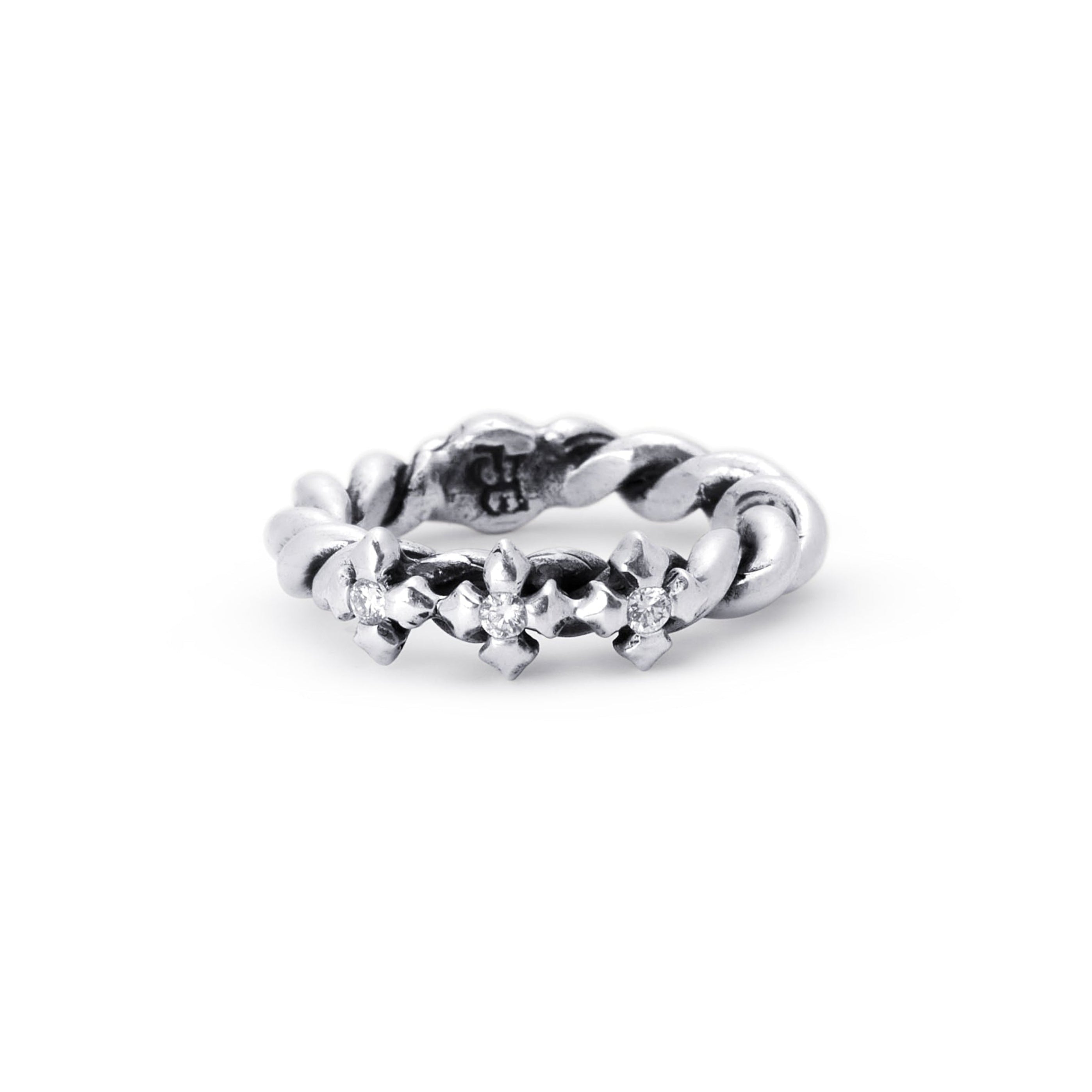 A sterling silver ring featuring a textured, floral or leaf-like pattern around the band, with lab diamonds photographed on a seamless white background.