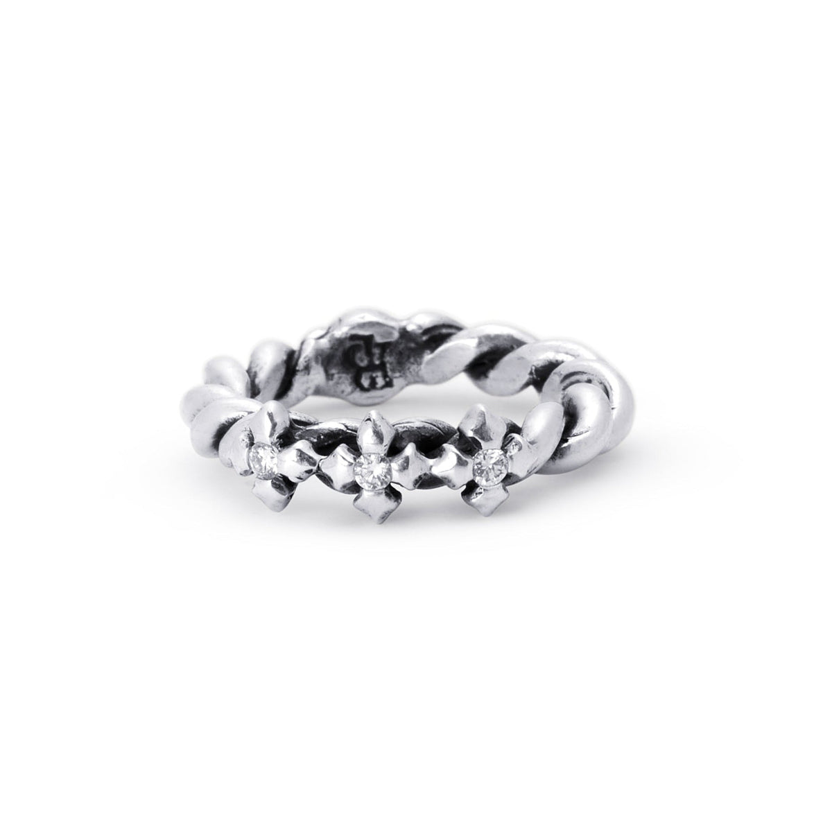 A sterling silver ring featuring a textured, floral or leaf-like pattern around the band, with lab diamonds photographed on a seamless white background.