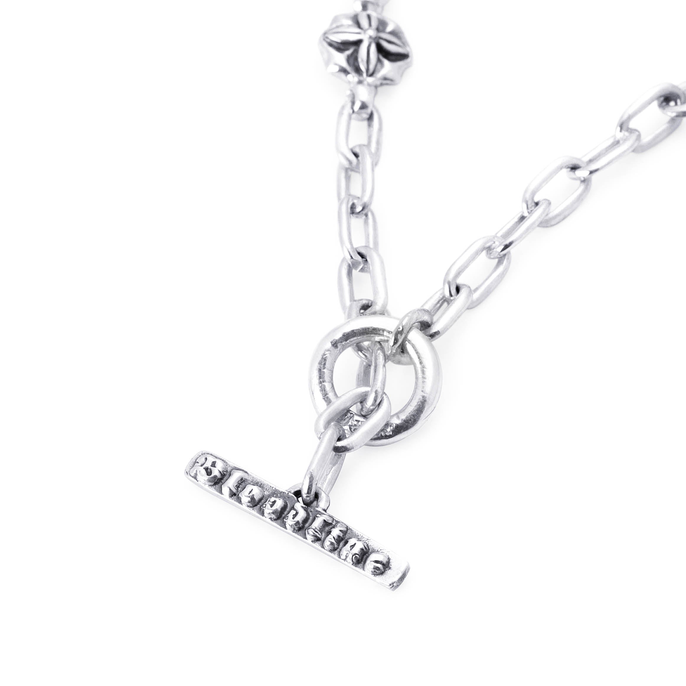 A silver-toned chain necklace featuring a toggle clasp with the word 'Bloodline' engraved across it, alongside a circular ring connector and a small star-shaped charm, shown against a plain white background.
