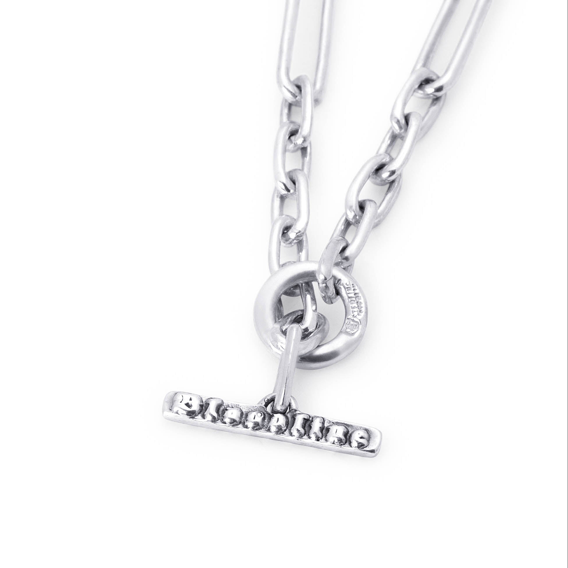 A silver-toned necklace featuring a flat paperclip chain, a circular ring connector, shown on a plain white background.