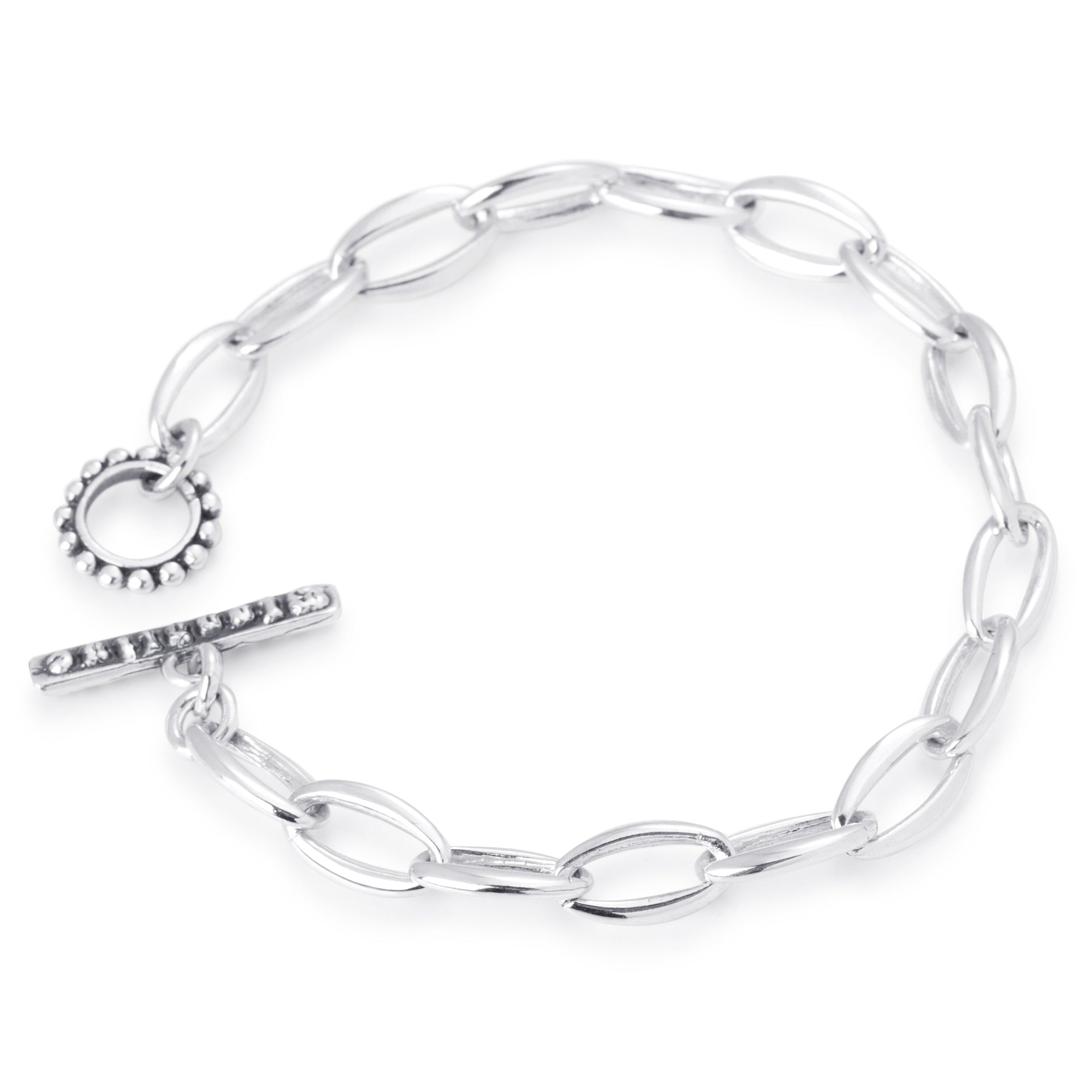 A sterling silver Manhattan link chain bracelet with a toggle clasp.