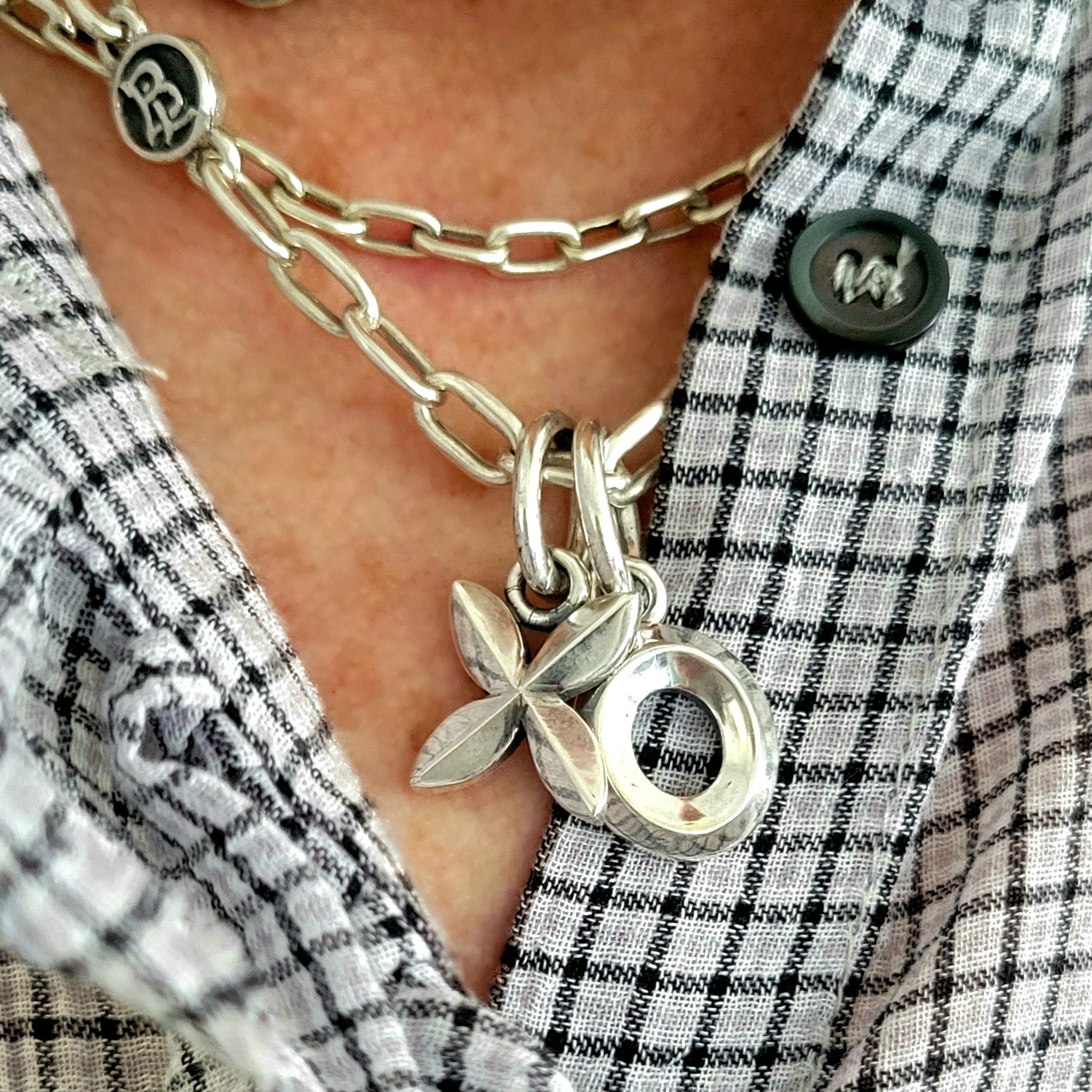 Woman wearing the X and O pendants sterling silver 