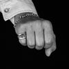 Mens hand wearing the sterling silver medium forged trapped skulls Signet ring on his pinky