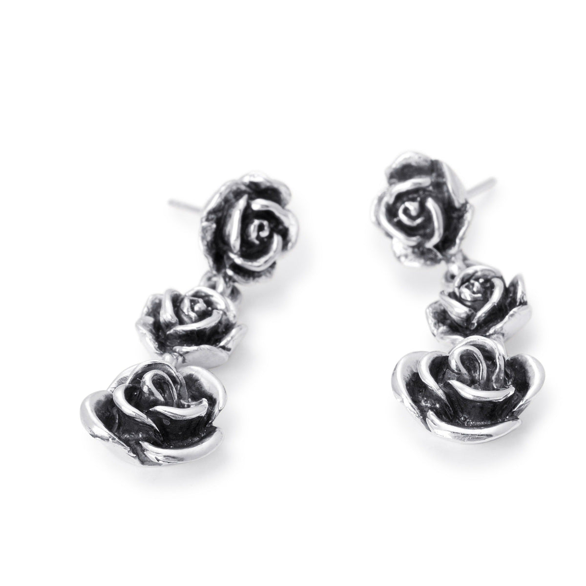 A pair of sterling silver drop earrings featuring three rose designs - Bloodline Design