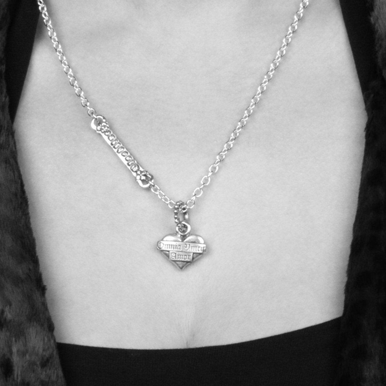 Model wearing our Solid Sterling Silver Classic Heart Pendant with Omnia Vincit  Amor etched on the face