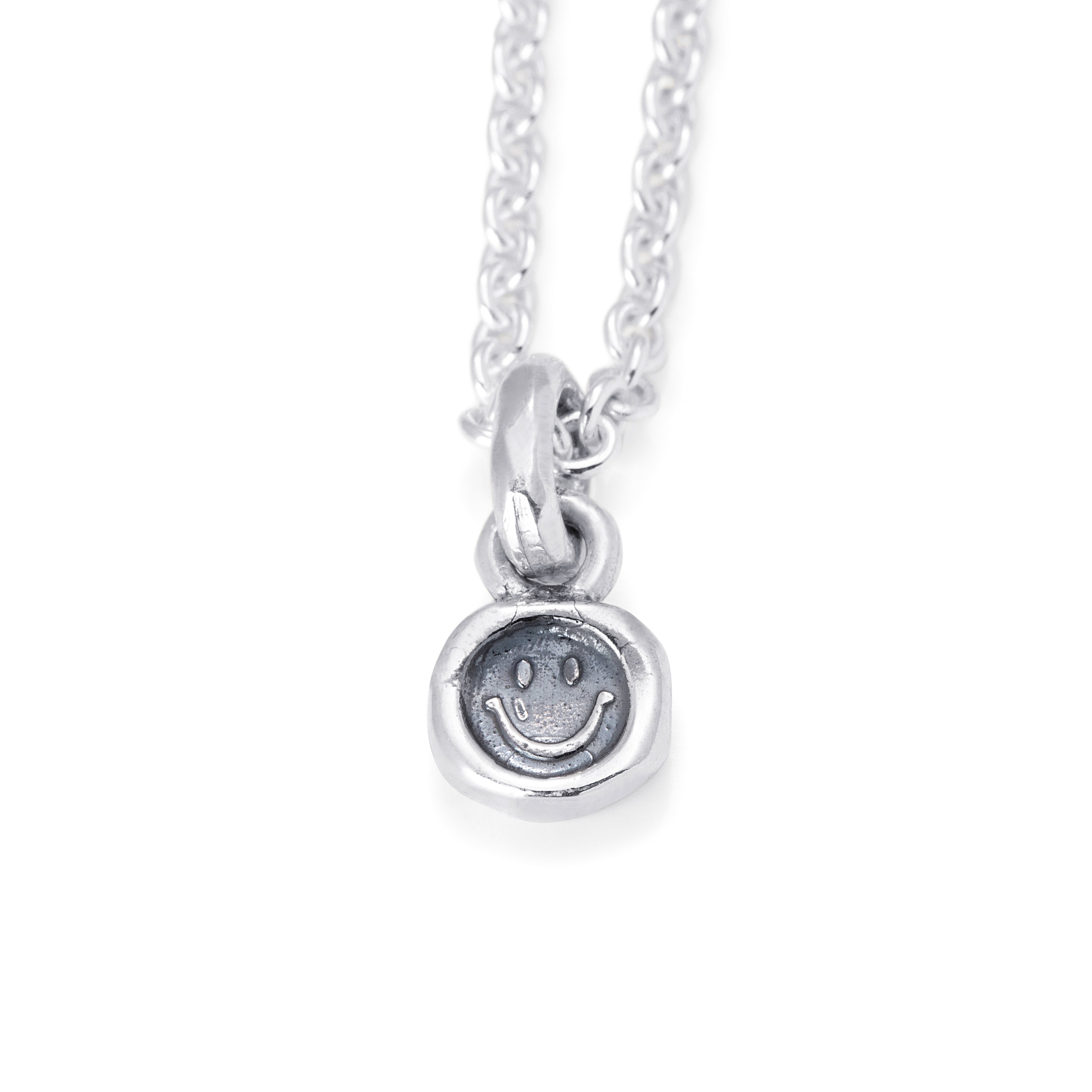 Solid Sterling Silver tablet style pendant stamped with a smiling face design.