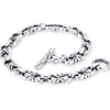 A solid sterling silver bracelet with an ornate link joined by a sleek classic link.