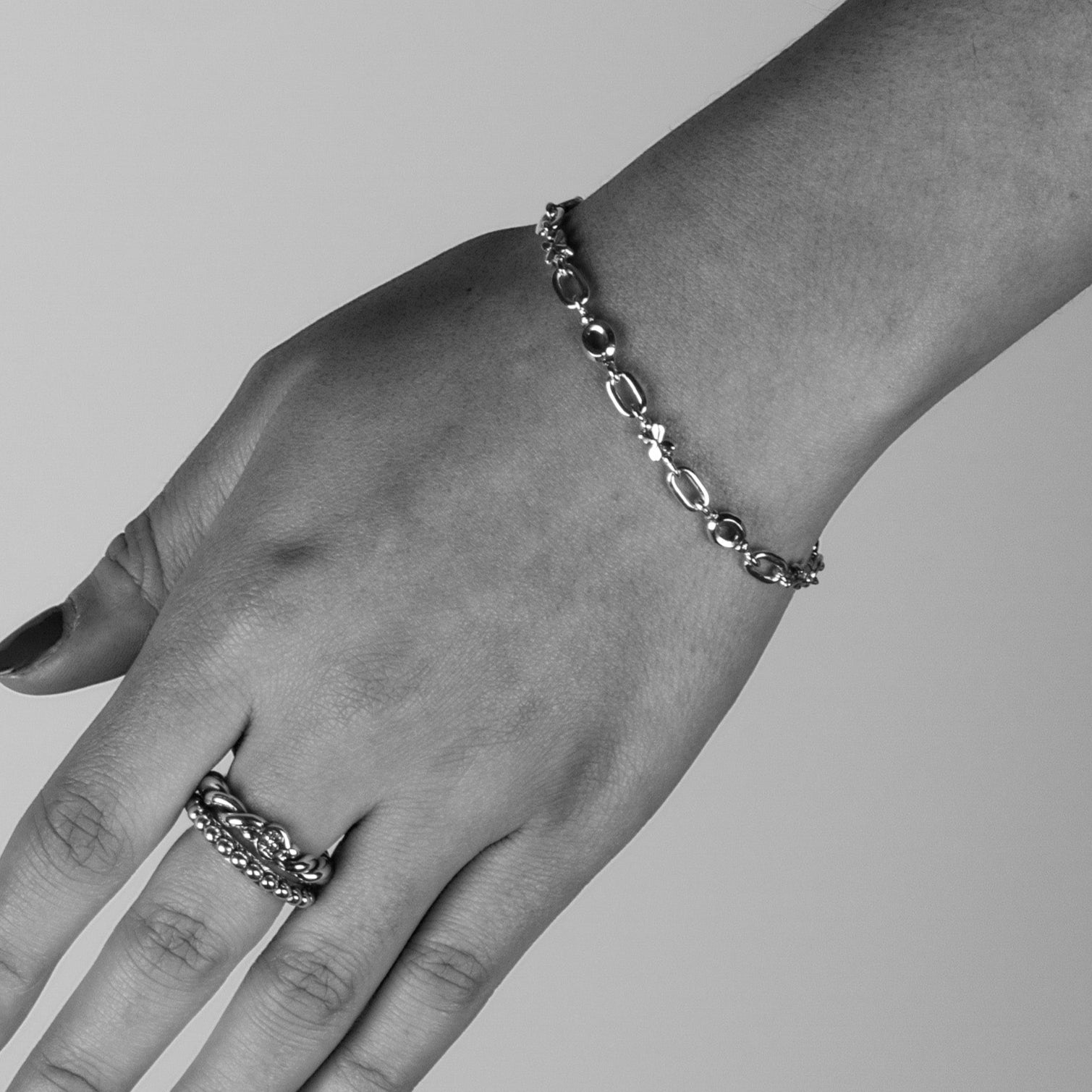 Solid Sterling Silver small X and O link Bracelet joined with classic open links, T-toggle clasp worn on a female's wrist.