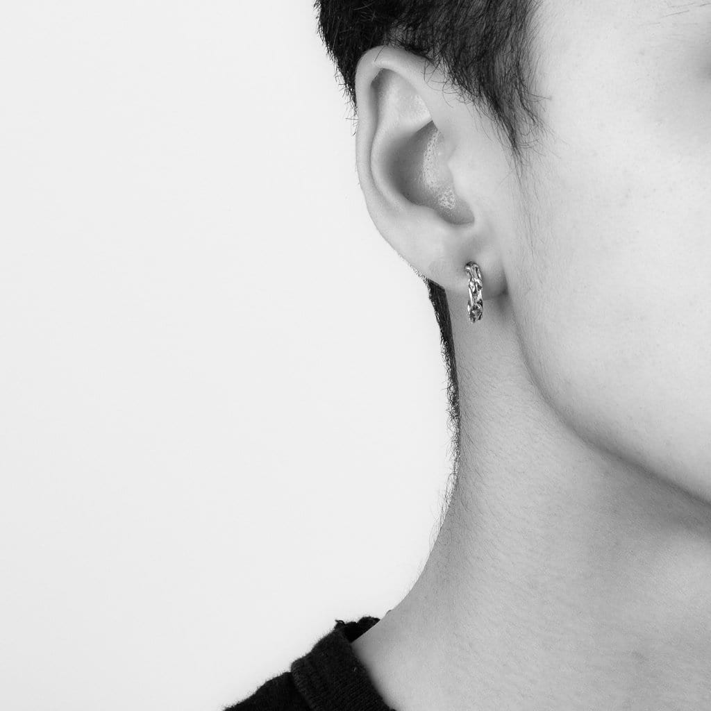 Small  hoop stud with vine texture, shown on earlobe.