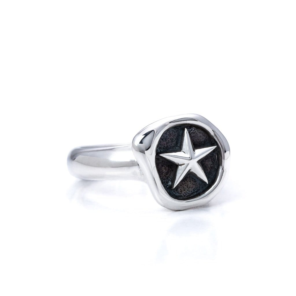 Solid Sterling Silver ring, wax stamp head on the ring with a star revealed. Side view