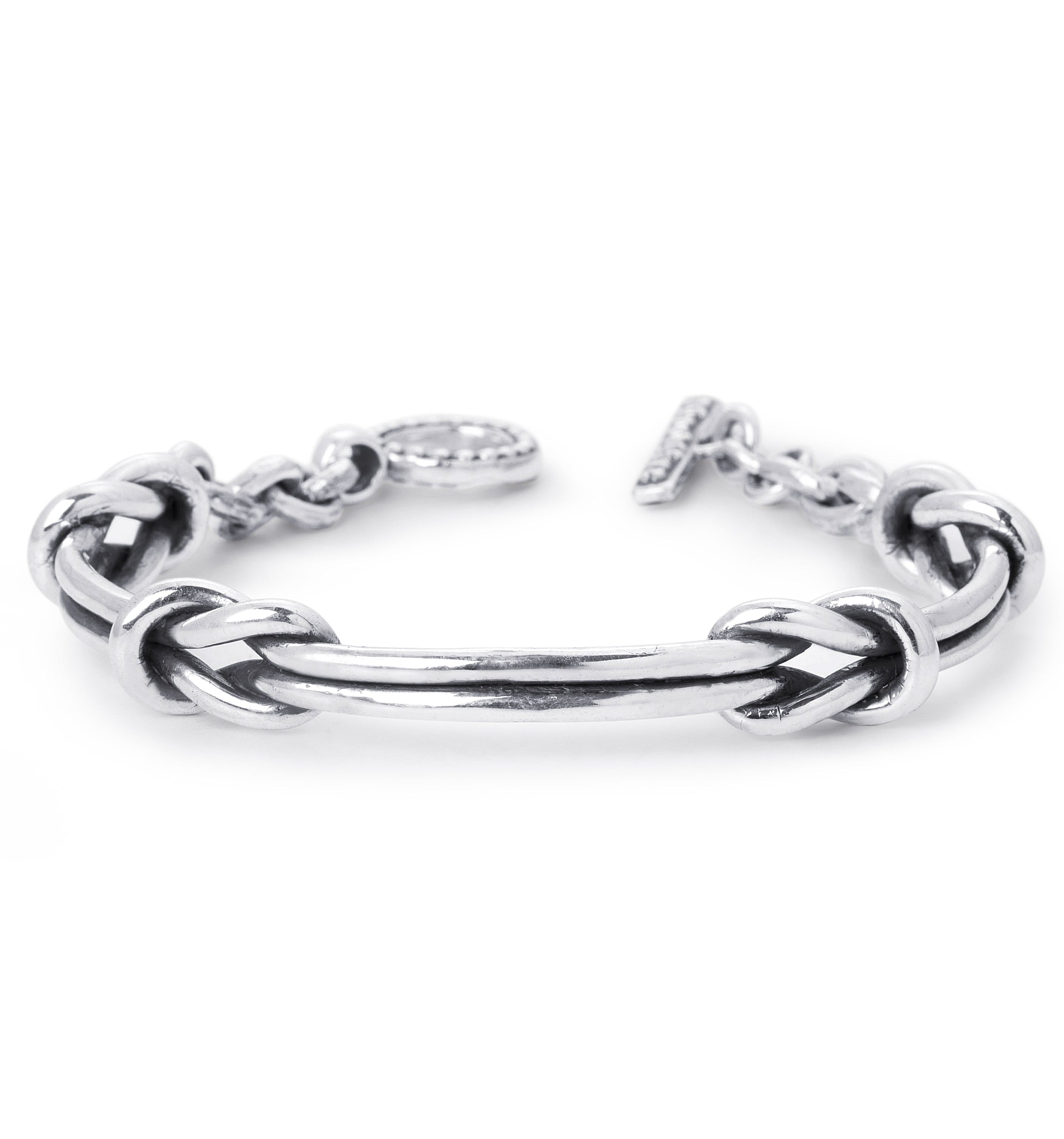a sterling silver cuff bracelet with two nautical knots on a white background