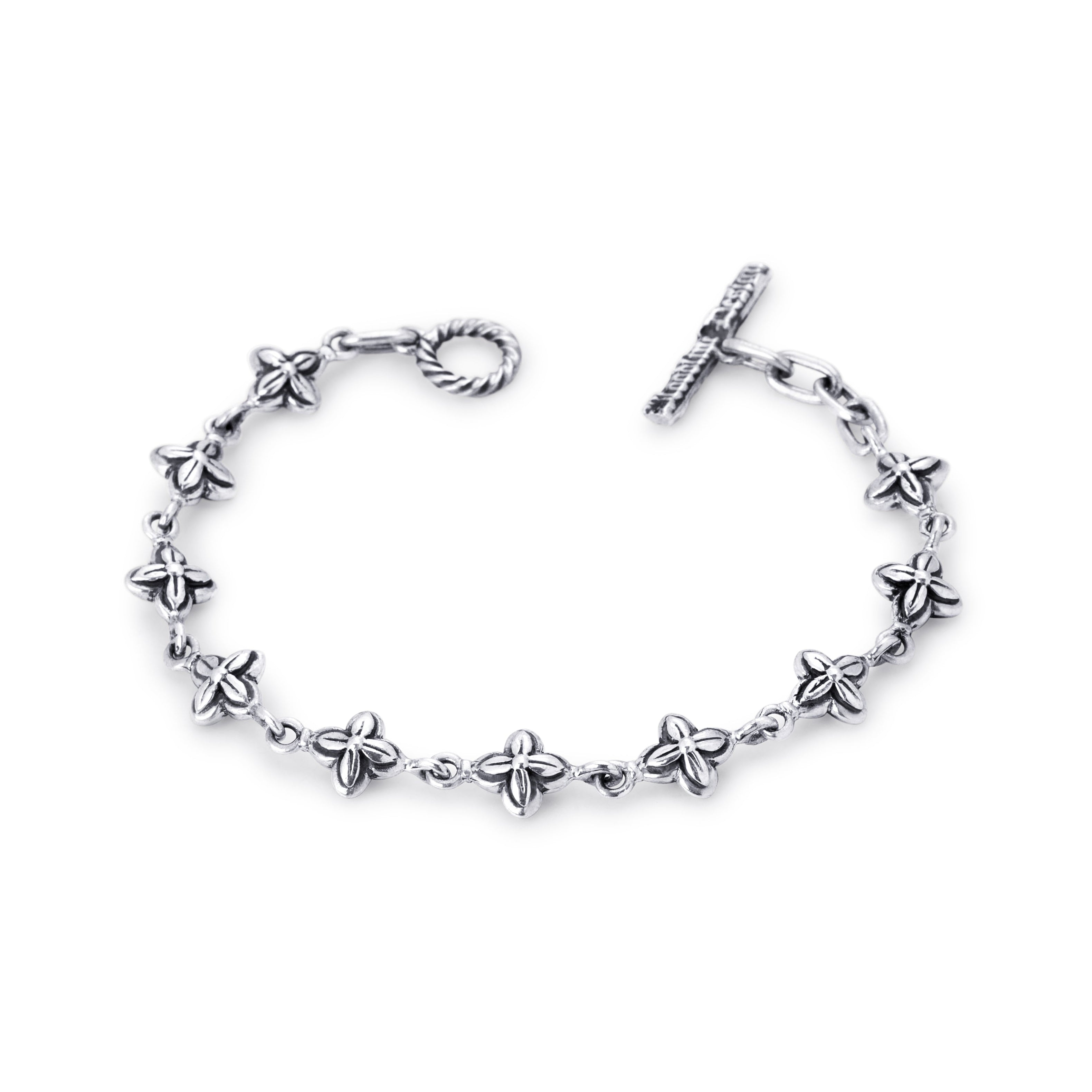 A silver-tone chain bracelet featuring small five-petal flower charms spaced along the link chain, with a twisted ring clasp and a toggle clasp on a plain white background.