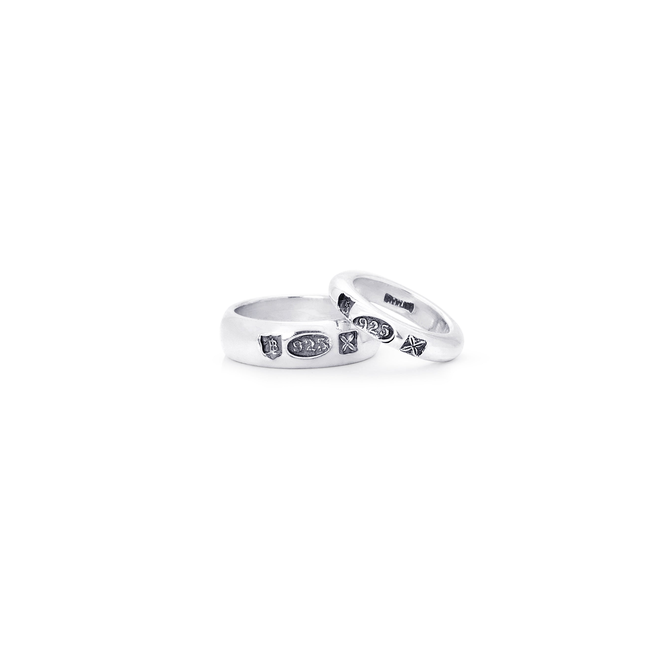 Two silver wedding bands with small black diamond accents, displayed on a clean white background.