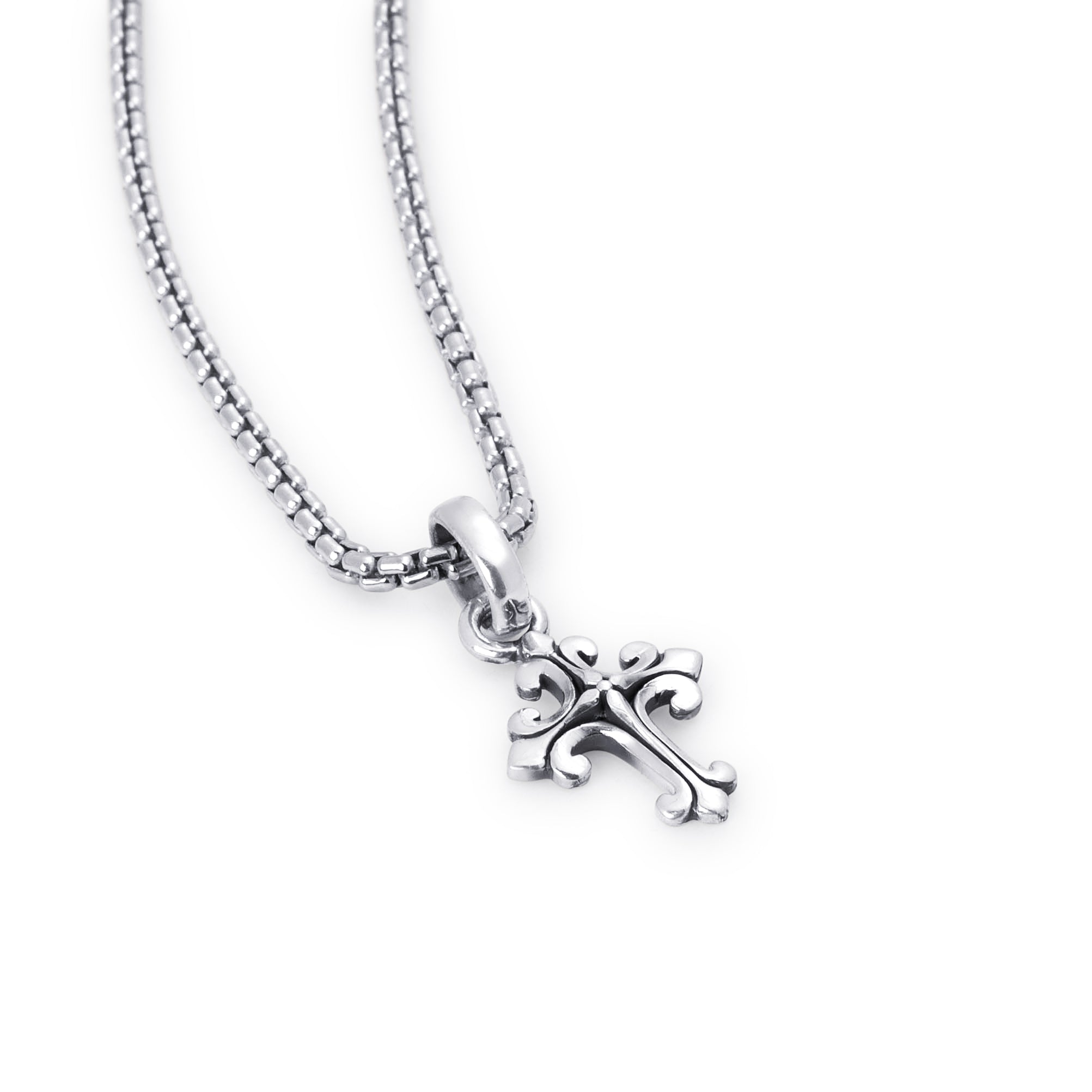 A silver cross pendant necklace with an ornate, stylized design, hanging from a silver box chain against a plain white background.