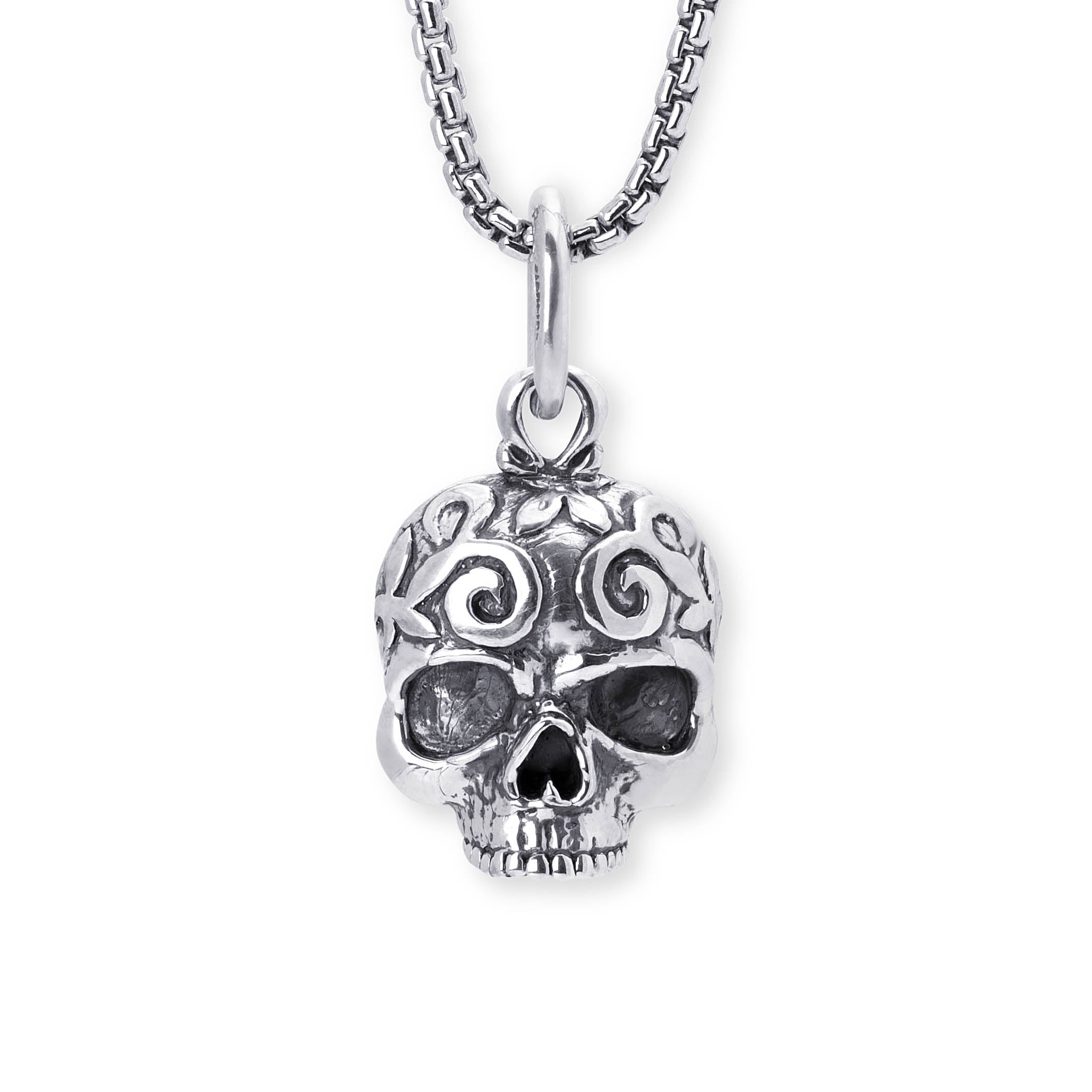 A silver skull pendant necklace with intricate filigree cutouts and a matching silver box chain, shown against a plain white background.