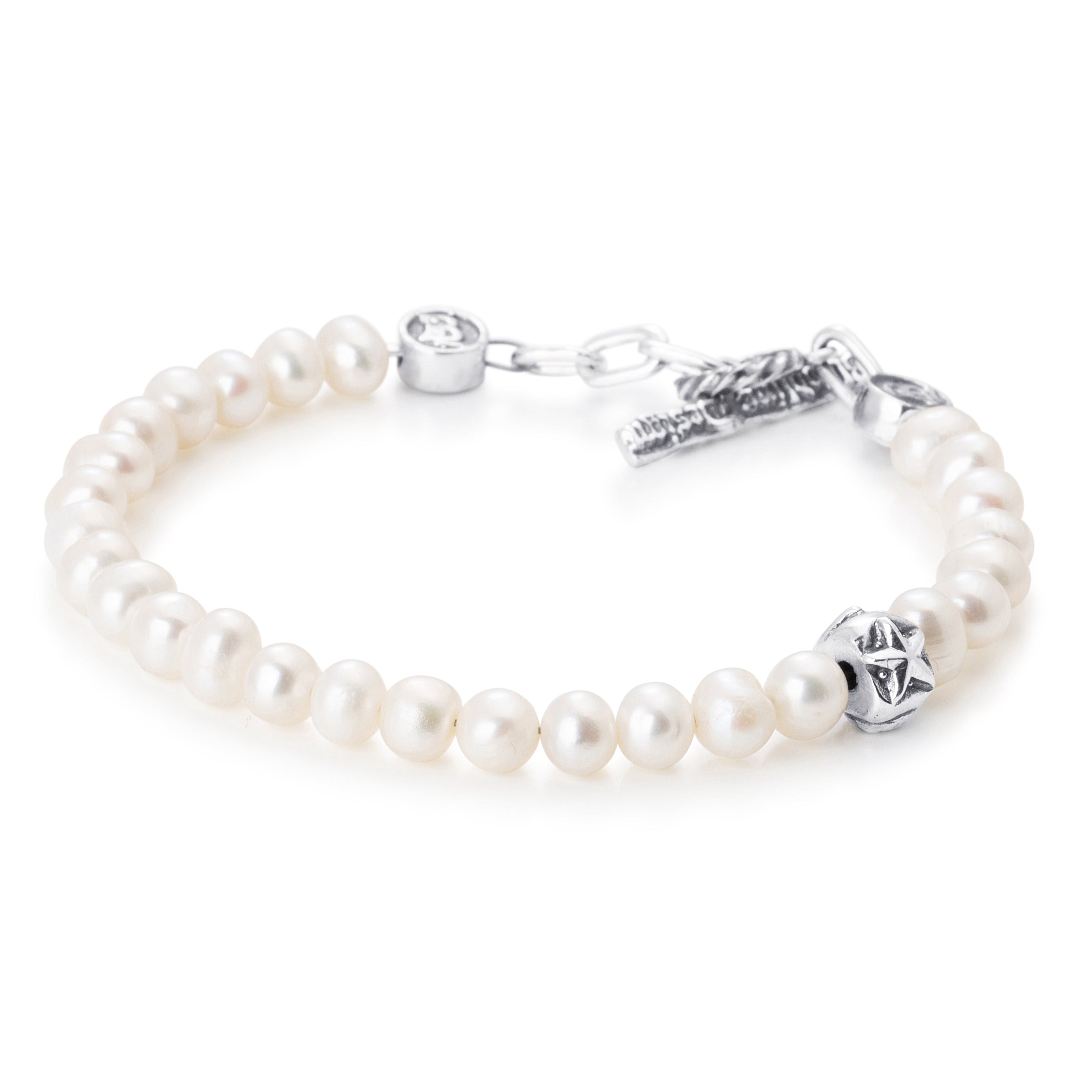 Pearls paired with a single sterling silver bead engraved with a heart star and skull on a stainless steel cable with Sterling silver T clasp.