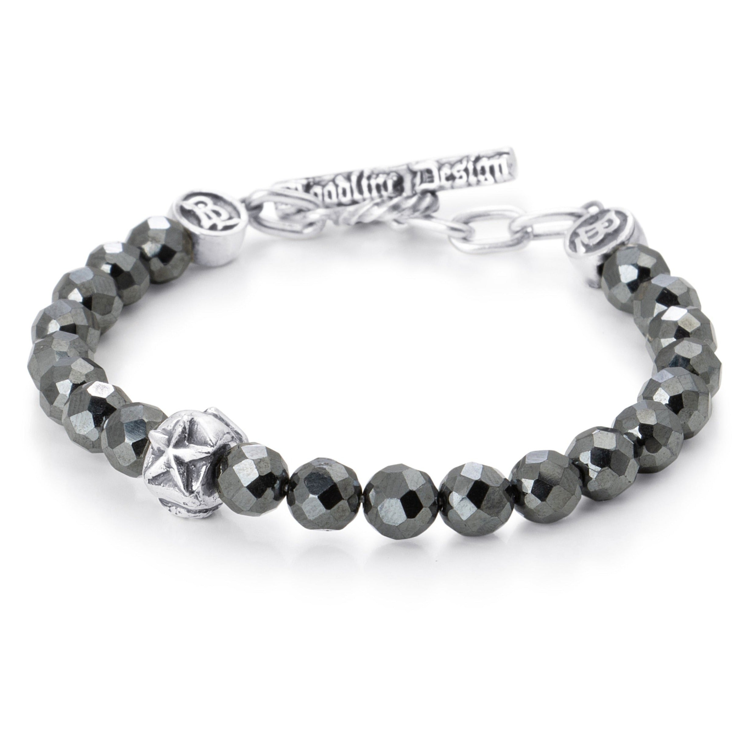 Facetted Hematite beads paired with a single sterling silver bead engraved with a heart star and skull on a stainless steel cable with Sterling silver T clasp.