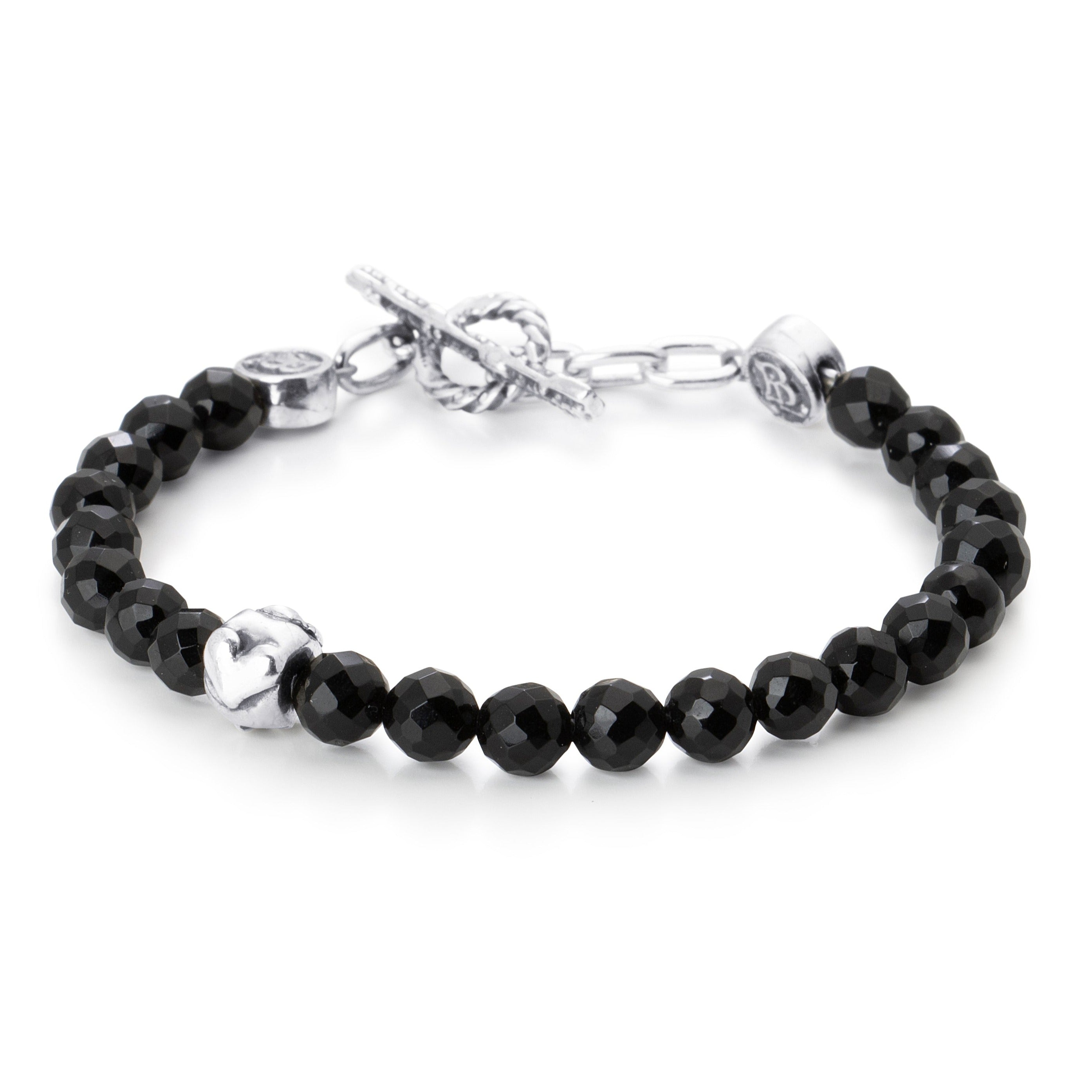 Facetted Onyx beads paired with a single sterling silver bead engraved with a heart star and skull on a stainless steel cable with Sterling silver T clasp.