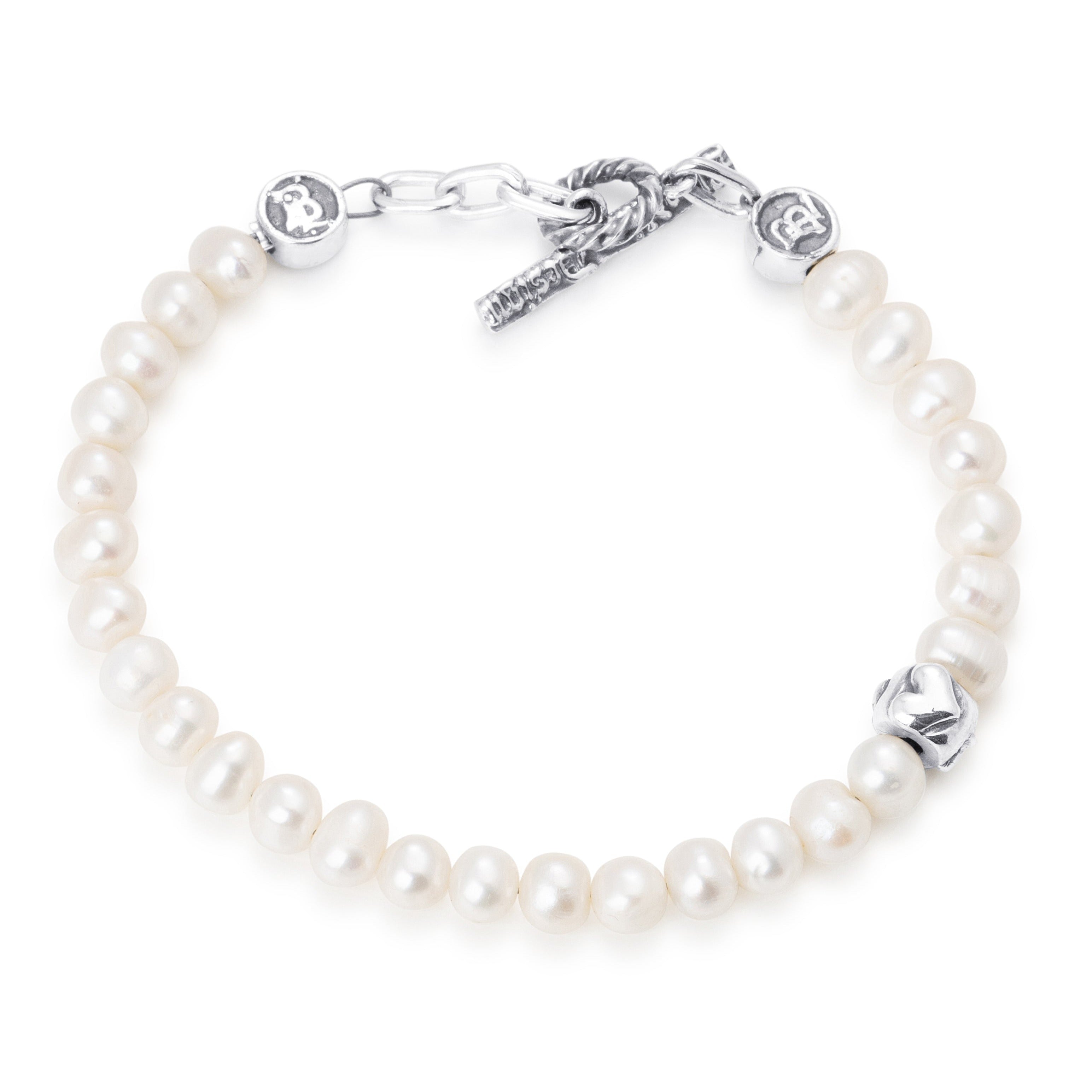 Pearls paired with a single sterling silver bead engraved with a heart star and skull on a stainless steel cable with Sterling silver T clasp.