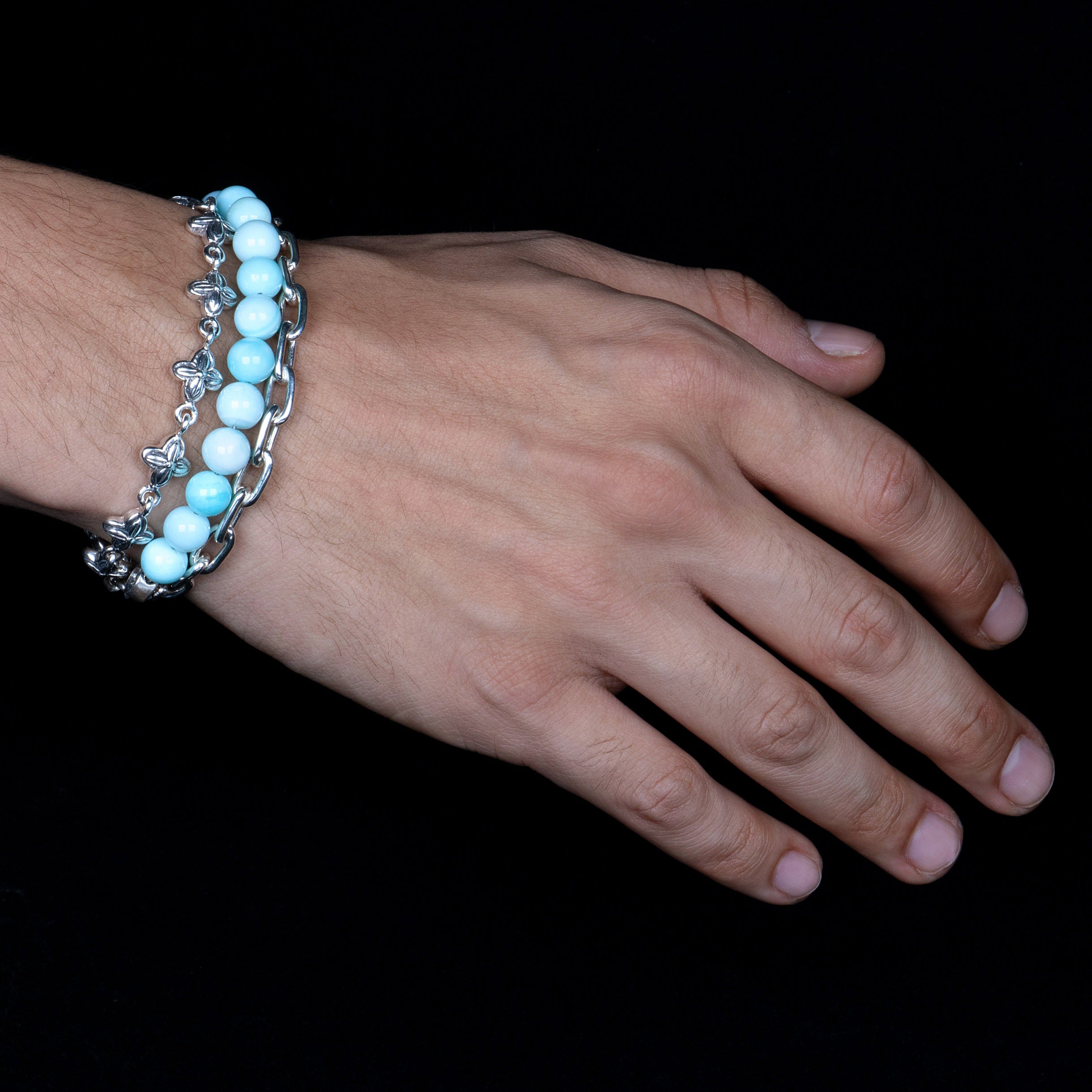 Circular Peruvian Opal beads on a stainless steel cable with Sterling silver T clasp. Shown on model.