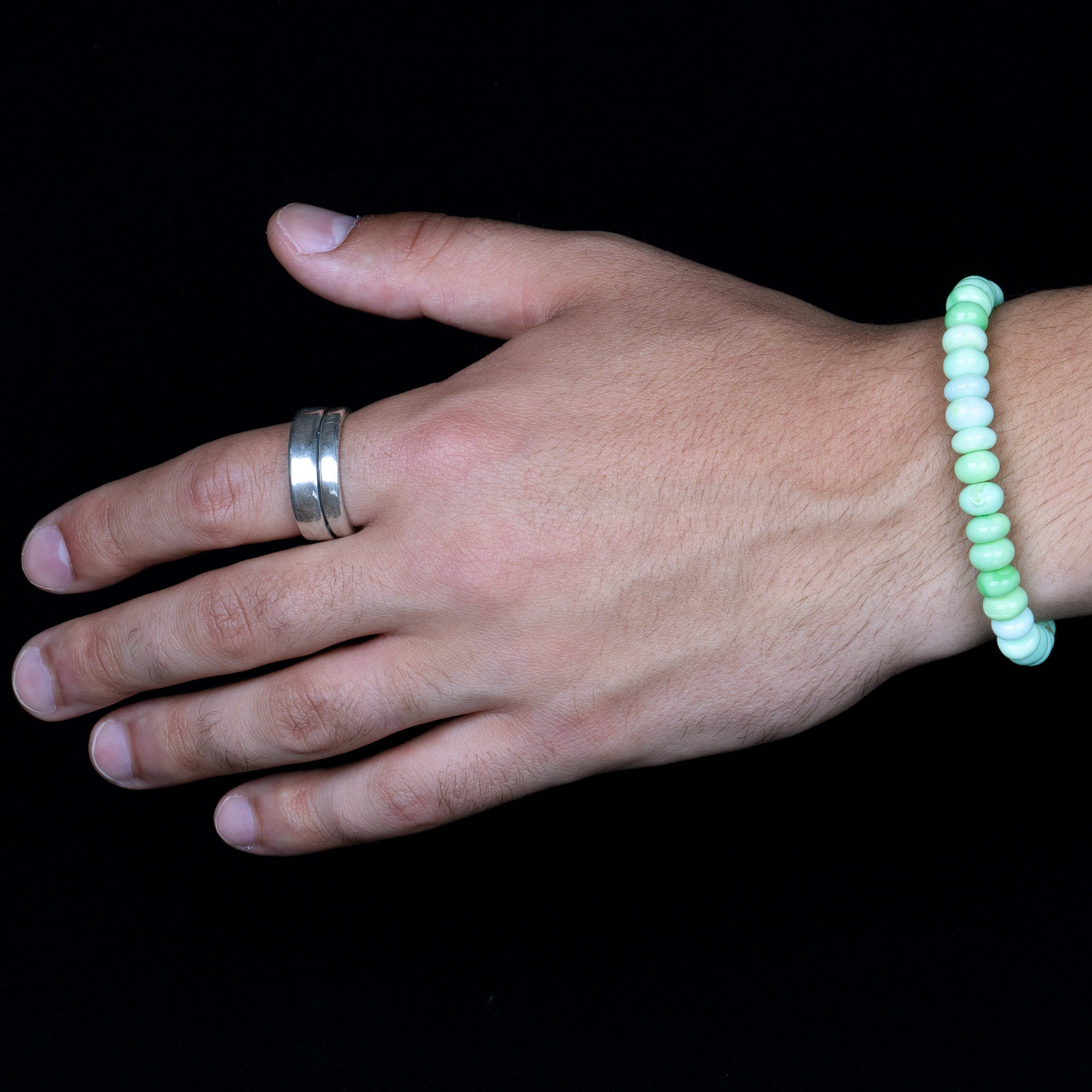 Oval Green Peruvian Opal beads on a stainless steel cable with Sterling silver T clasp. Shown on Hand model.