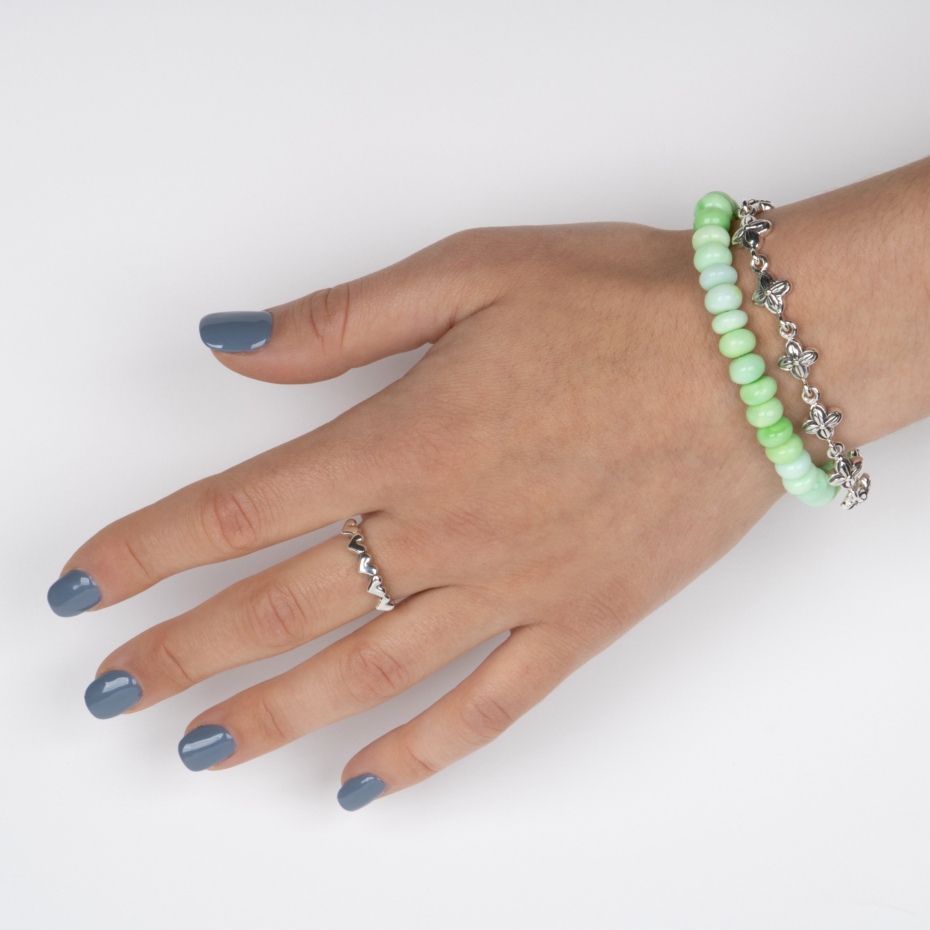 Oval Green Peruvian Opal beads on a stainless steel cable with Sterling silver T clasp. Shown on a model