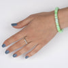 Oval Green Peruvian Opal beads on a stainless steel cable with Sterling silver T clasp. Shown on a model.