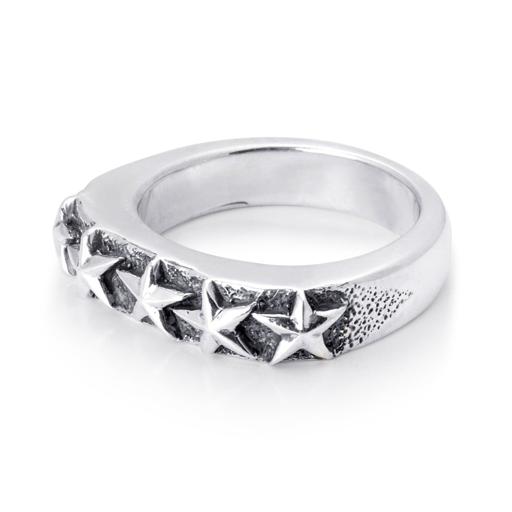 Solid sterling silver band with five stars exposed on the top. Pitting surrounds the stars on the top. 45 degree view of the Ring