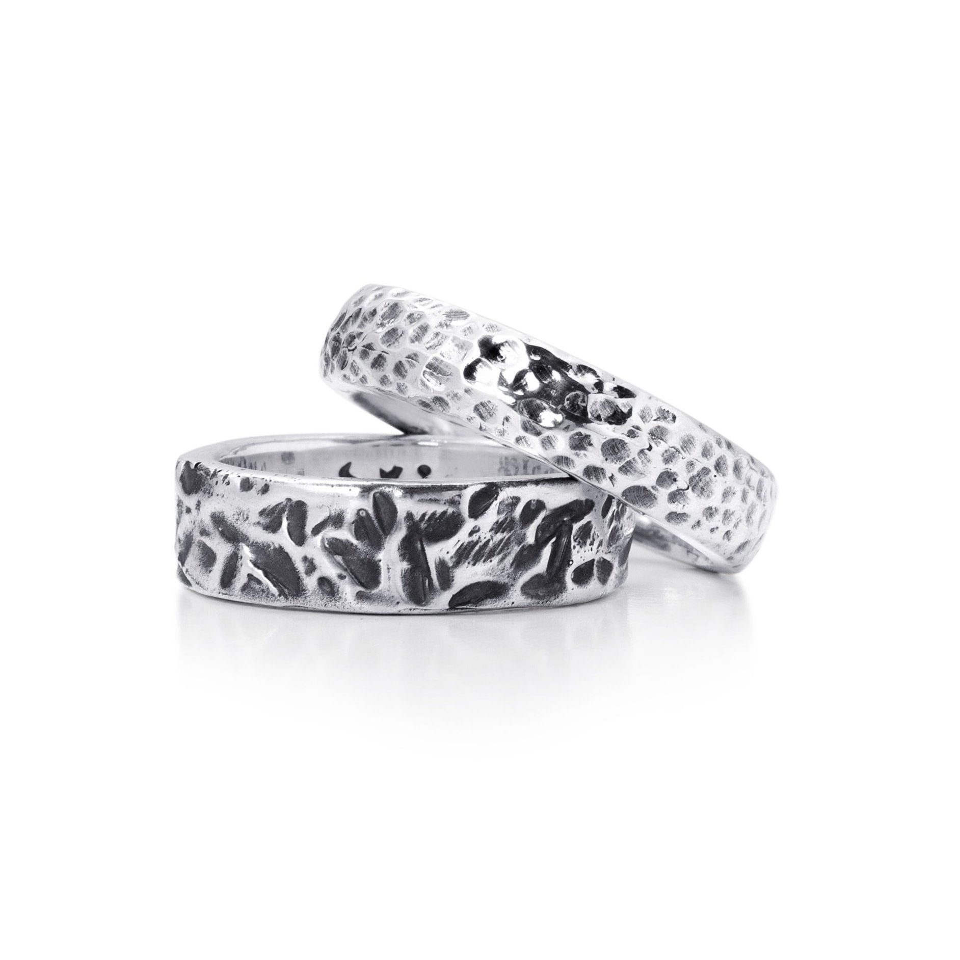 two sterling silver mens rings. The Medium Forged Band Ring and the Medium Hammered Band Ring.