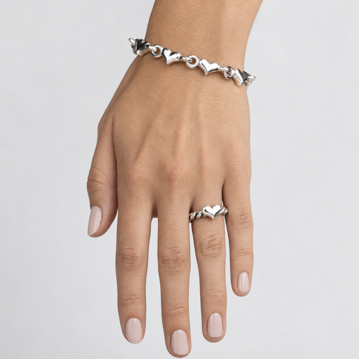 women's classic heart link sterling silver bracelet worn on wrist