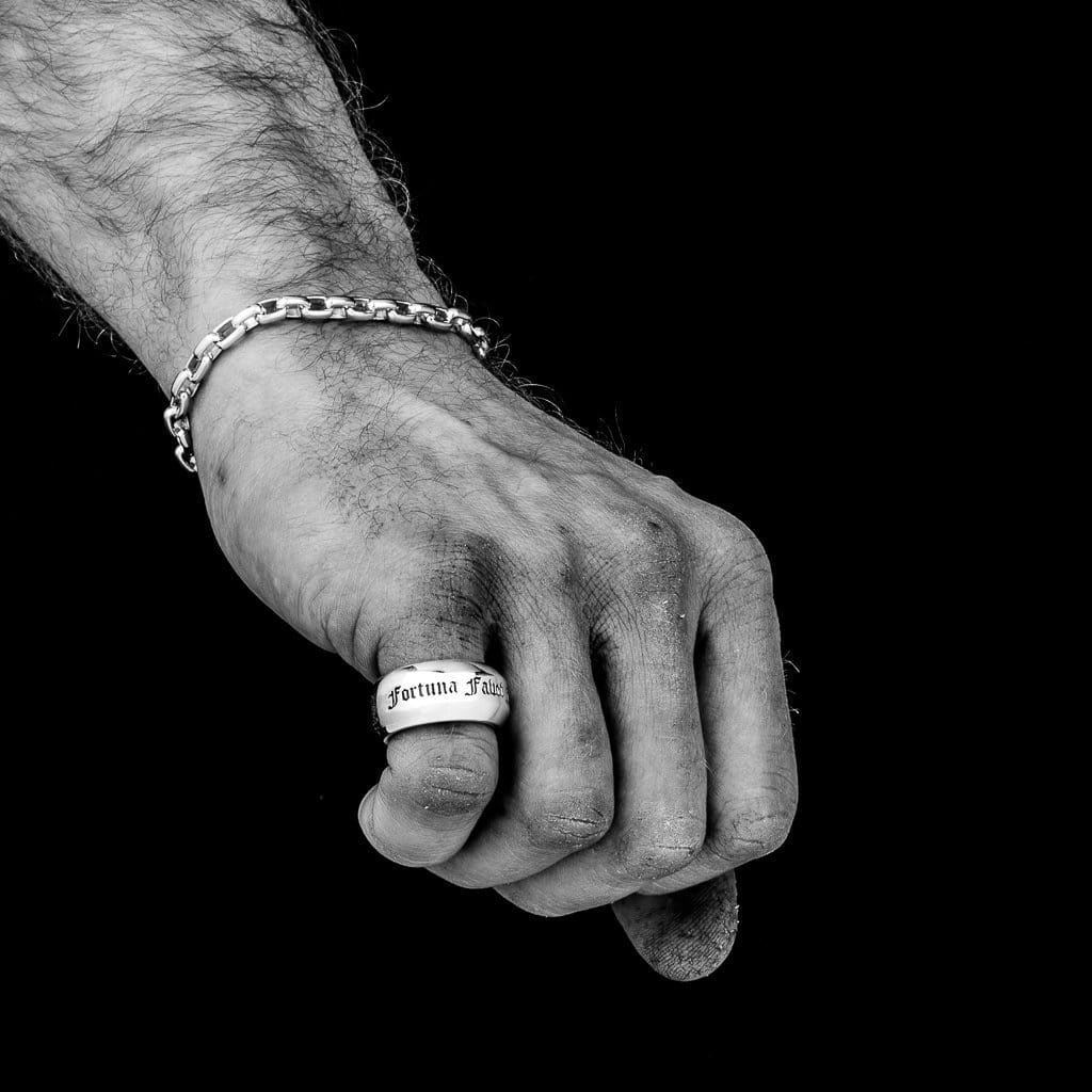 Large Solid Silver band inscribed with words in an old letter font on a male models hand