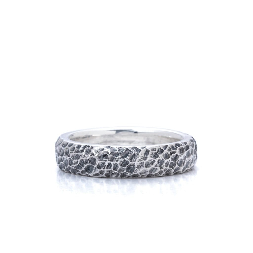 Solid Sterling silver band decorated with consistent hammered reliefs around the band