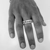 Solid Silver chain link ring with word bar at the head inscribed with "Amor" on a male model hand