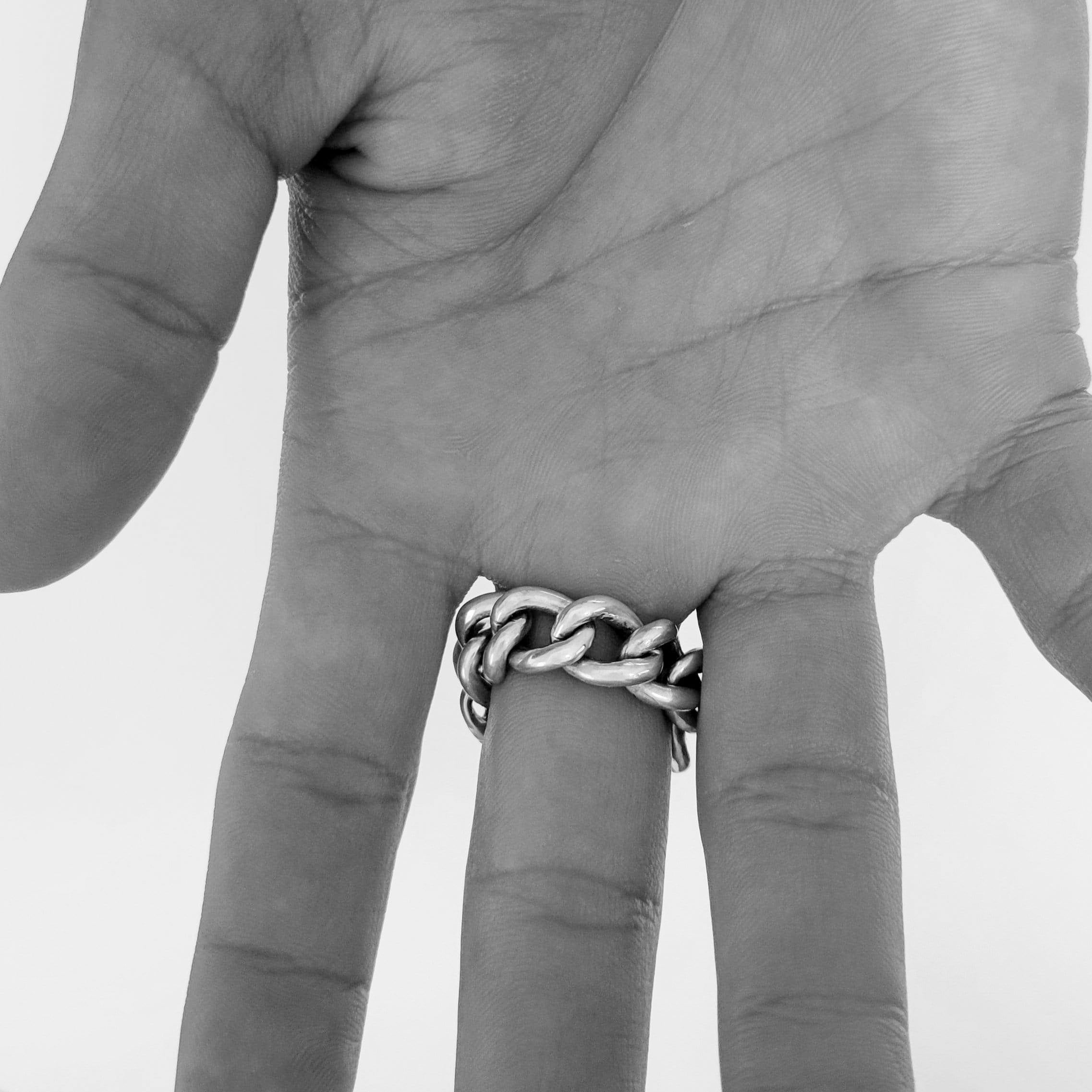 Solid Silver chain link ring on a male model hand focusing on chain links of the ring